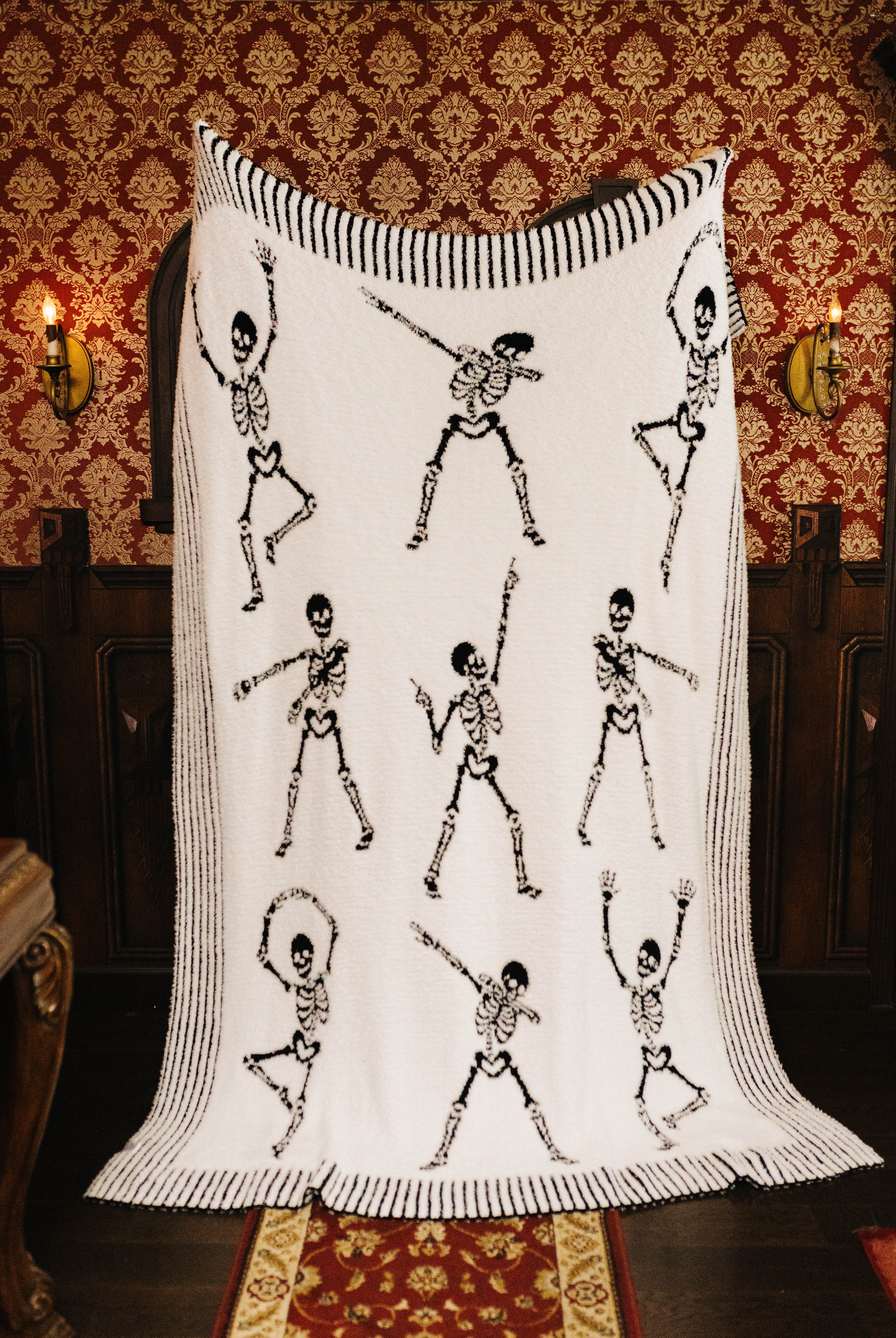 Skelly blanket held open to show the reverse side