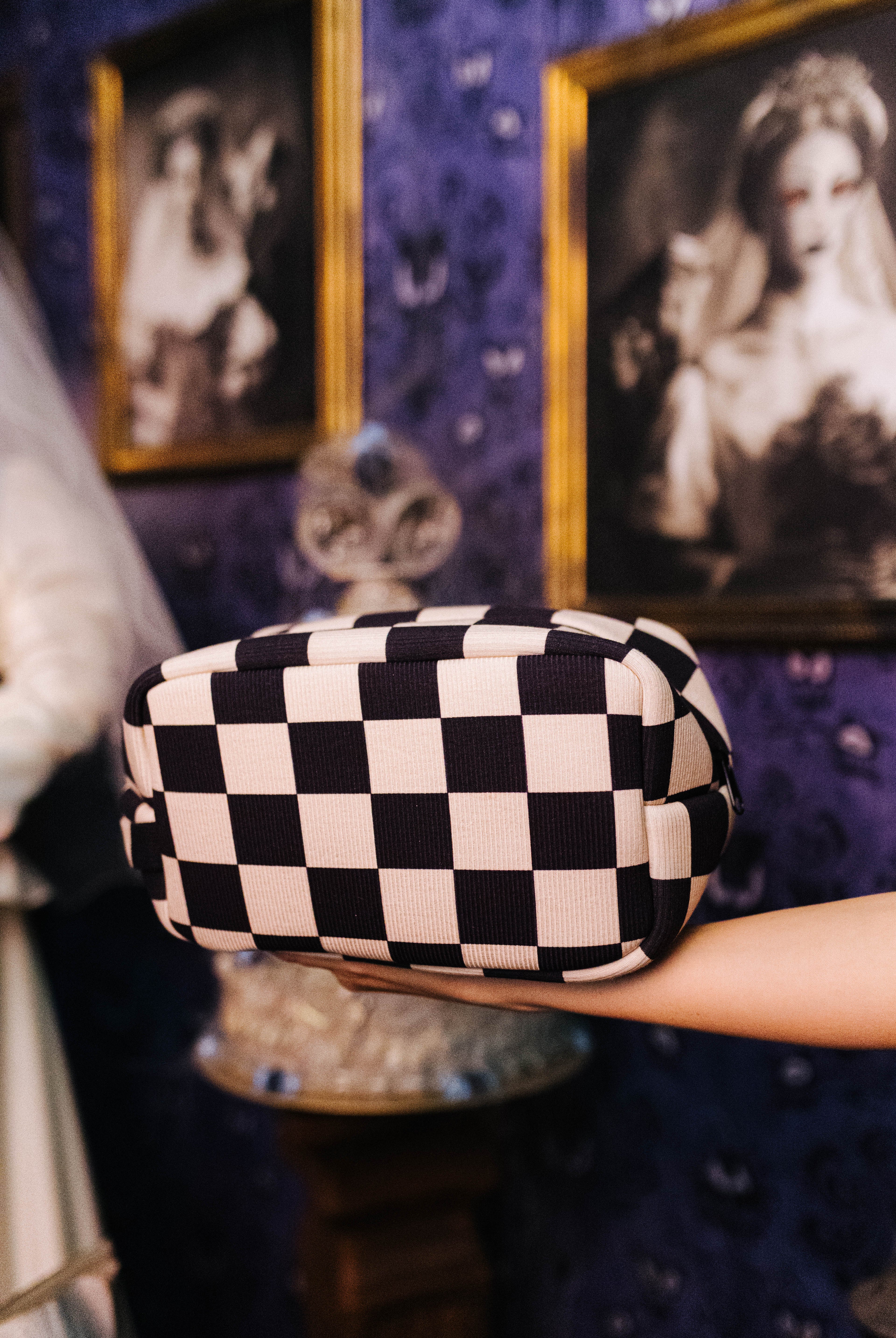Sand and black check cosmetic bag shown from the front