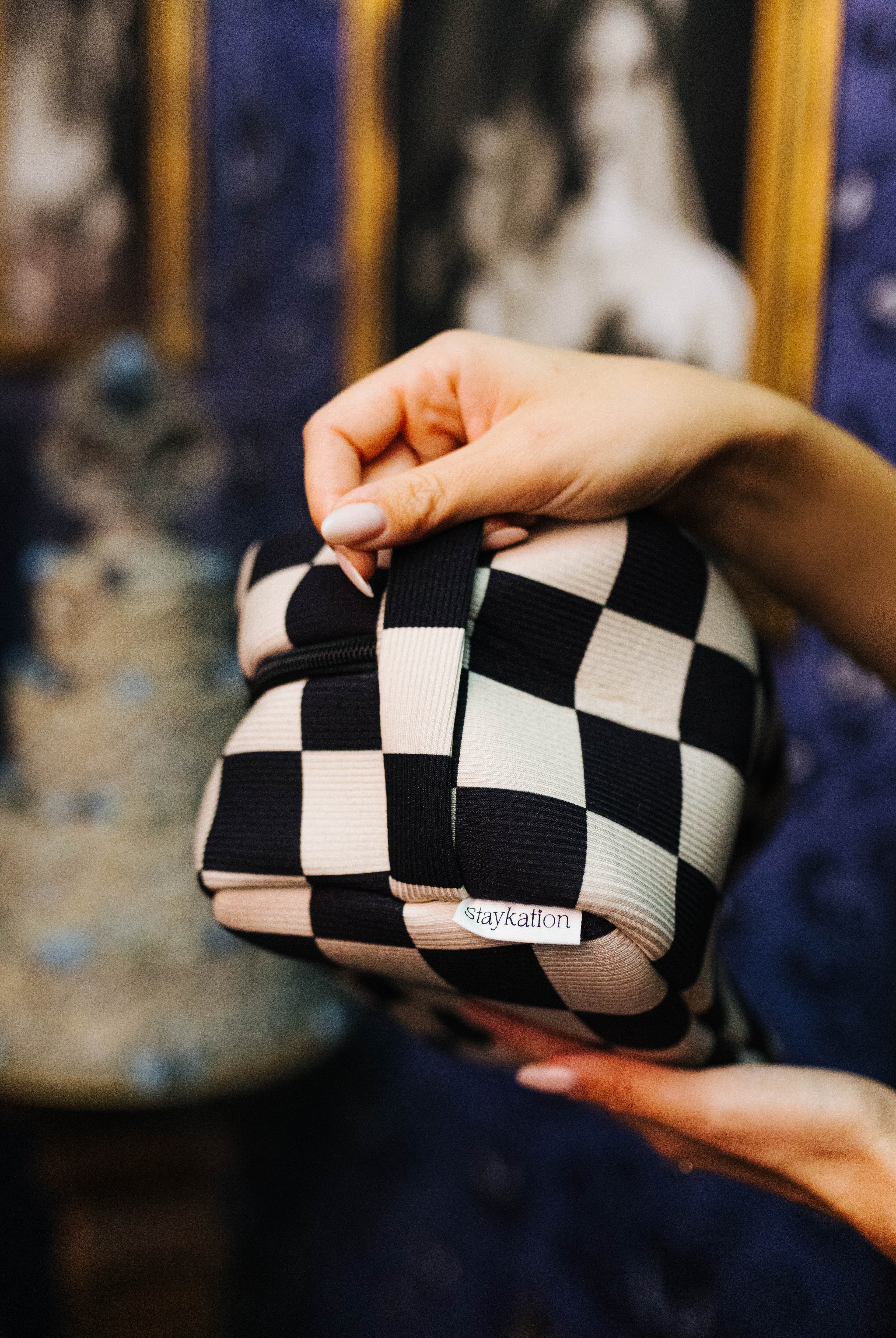 Sand & Black Check Cosmetic Bag shown in a full length lifestyle view