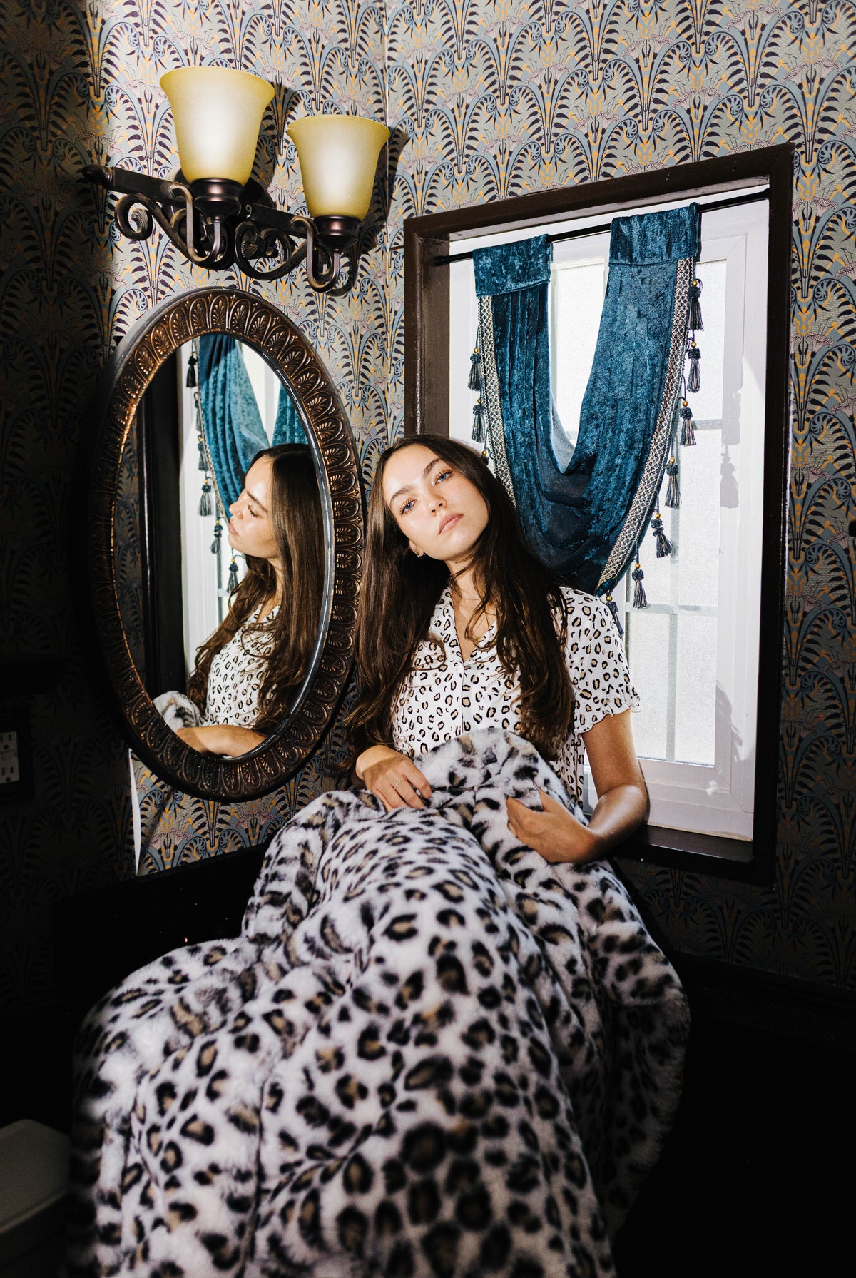Leopard Faux Fur Blanket 60x80 shown in a full length lifestyle view