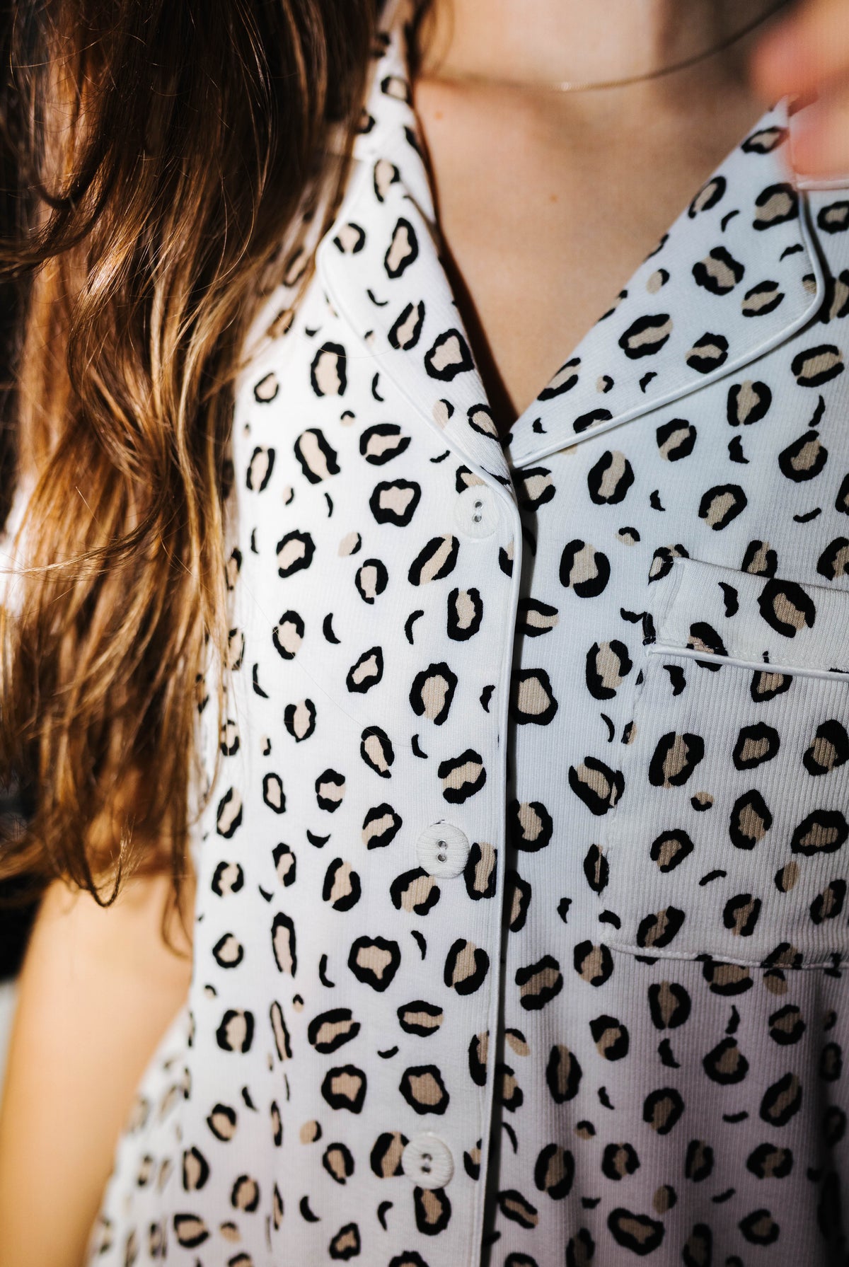 Close view of the collar and buttons on the leopard pajama top