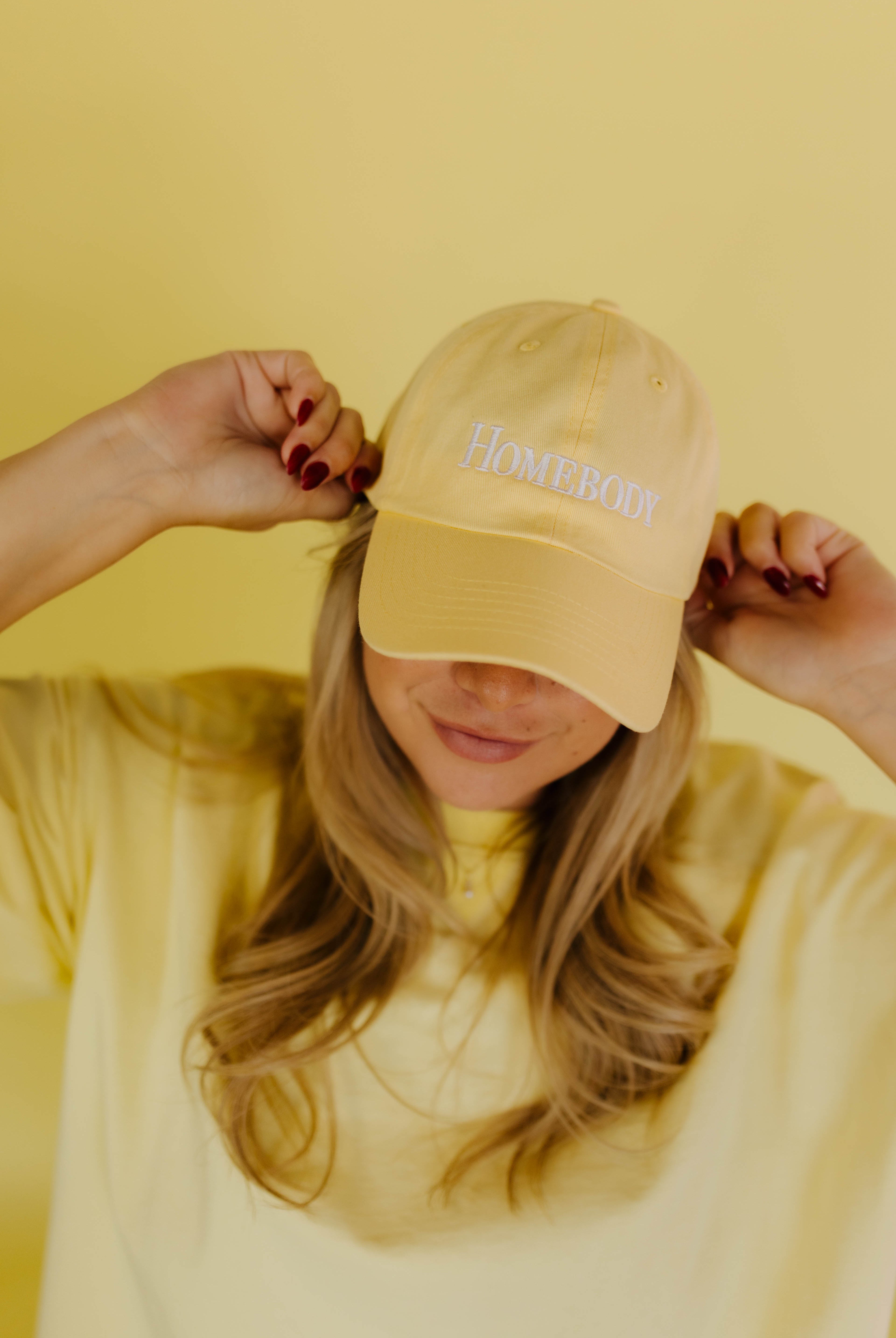 Yellow dad hat that says homebody