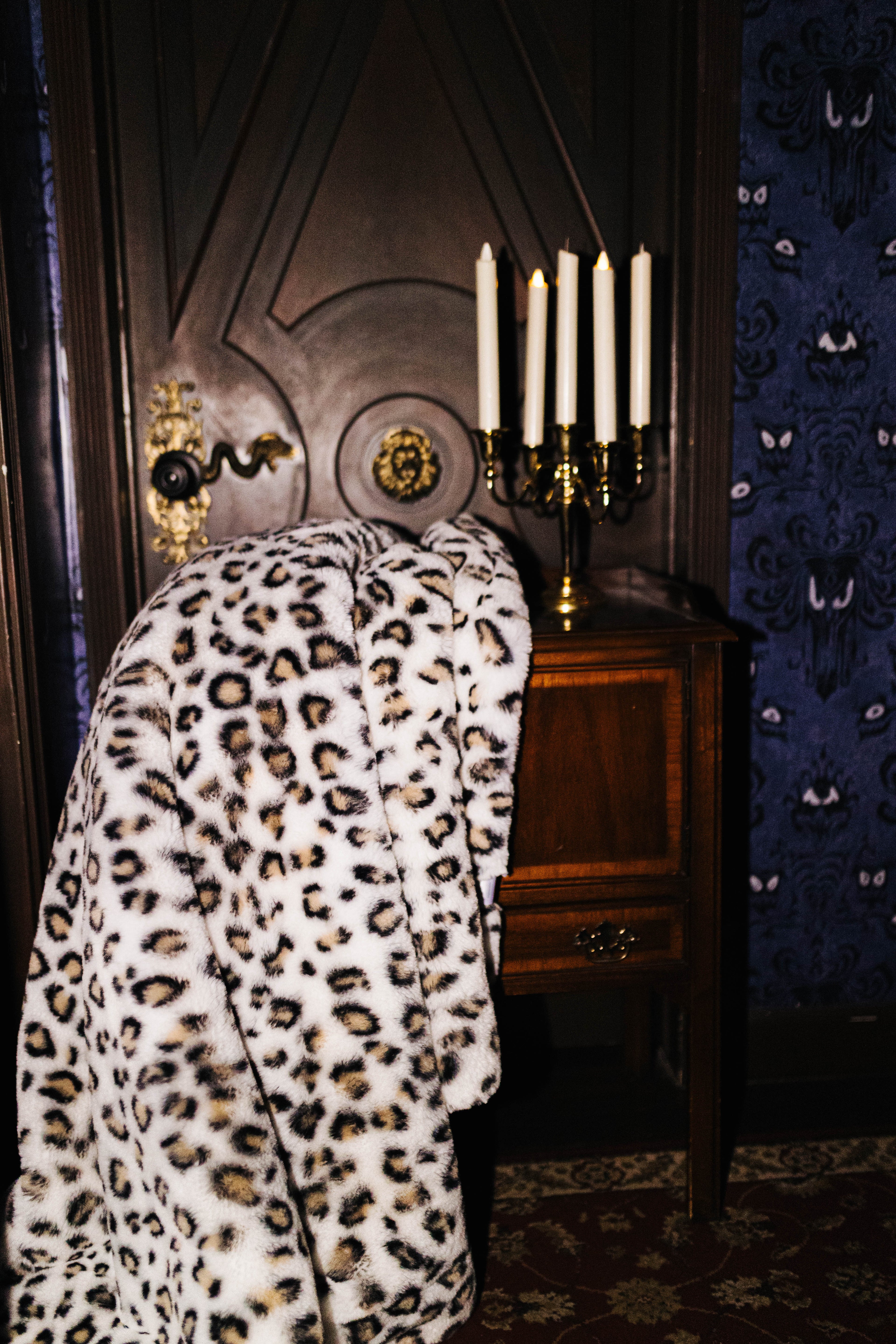 Leopard faux fur blanket draped over a chair
