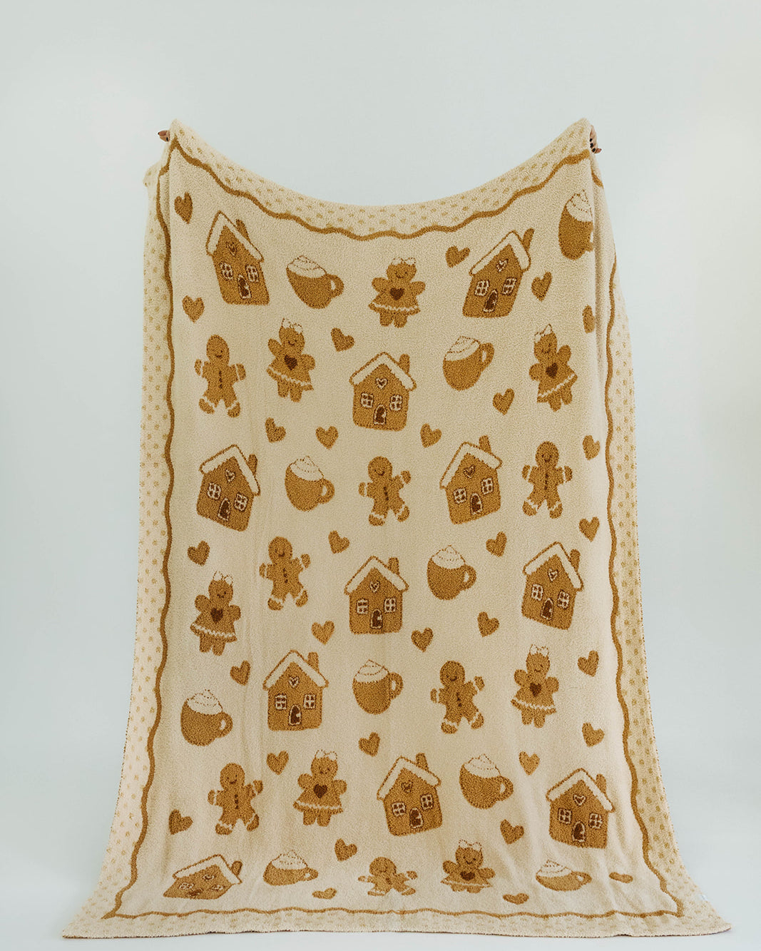 Fabric with gingerbread-themed patterns on a white background