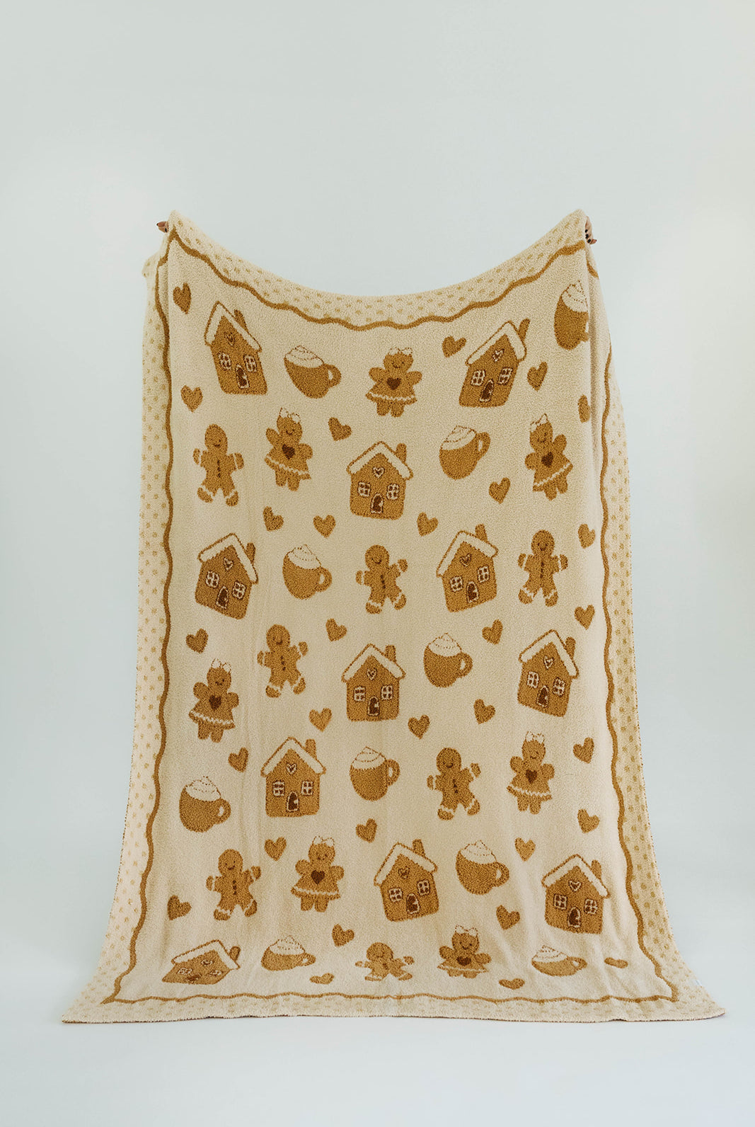 Fabric with gingerbread-themed patterns on a white background