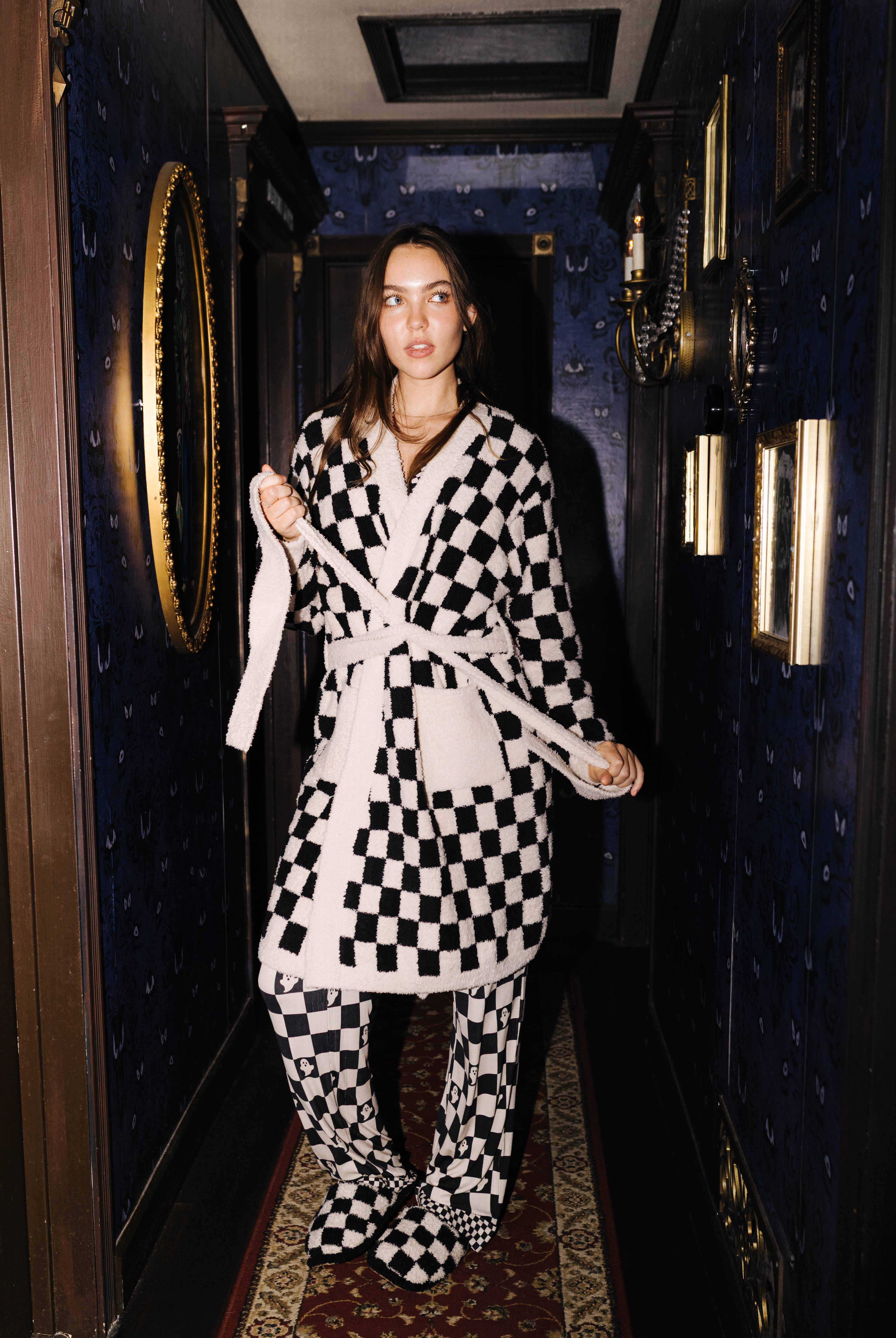 Front view of the sand and black check fluffy robe on a model