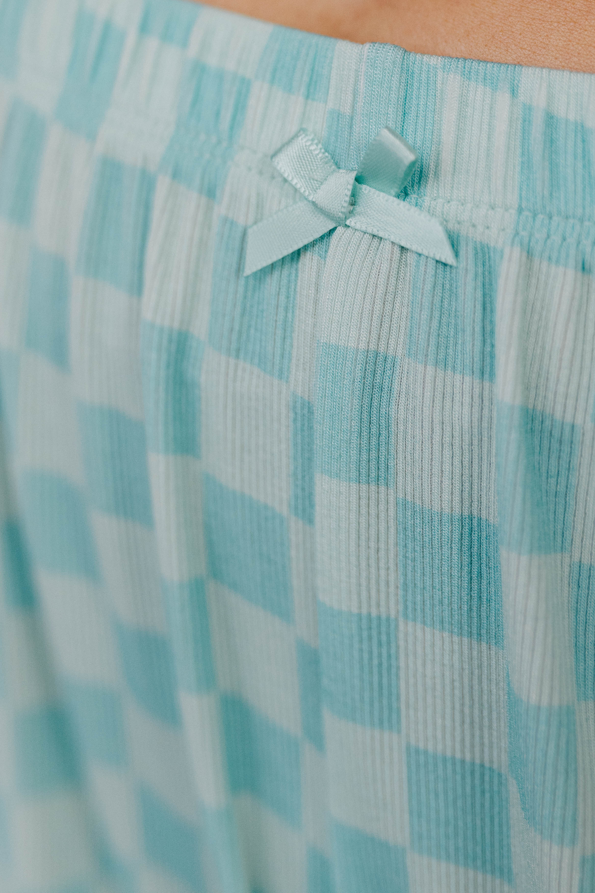 Close-up of a light blue bow detail