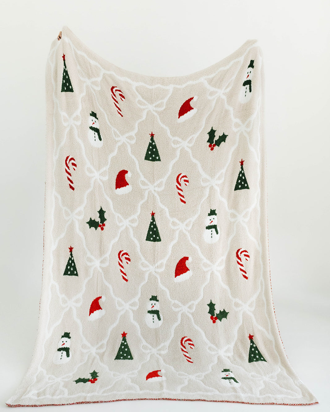 Decorative blanket with Christmas-themed patterns on a white background
