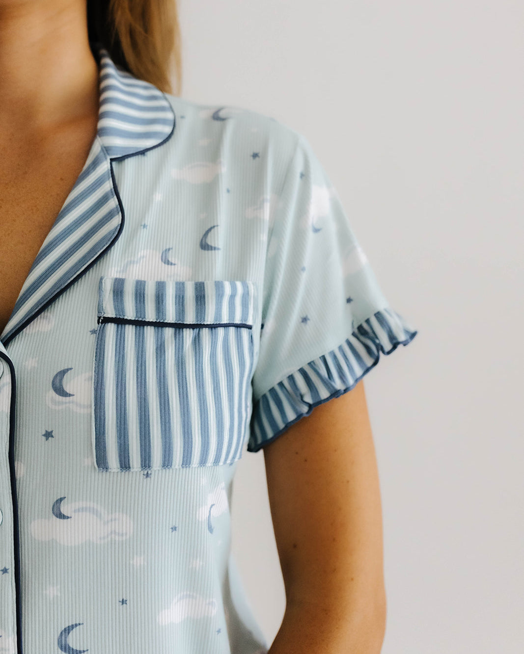 the cloud ruffle pajama top pocket and collar are blue and white striped
