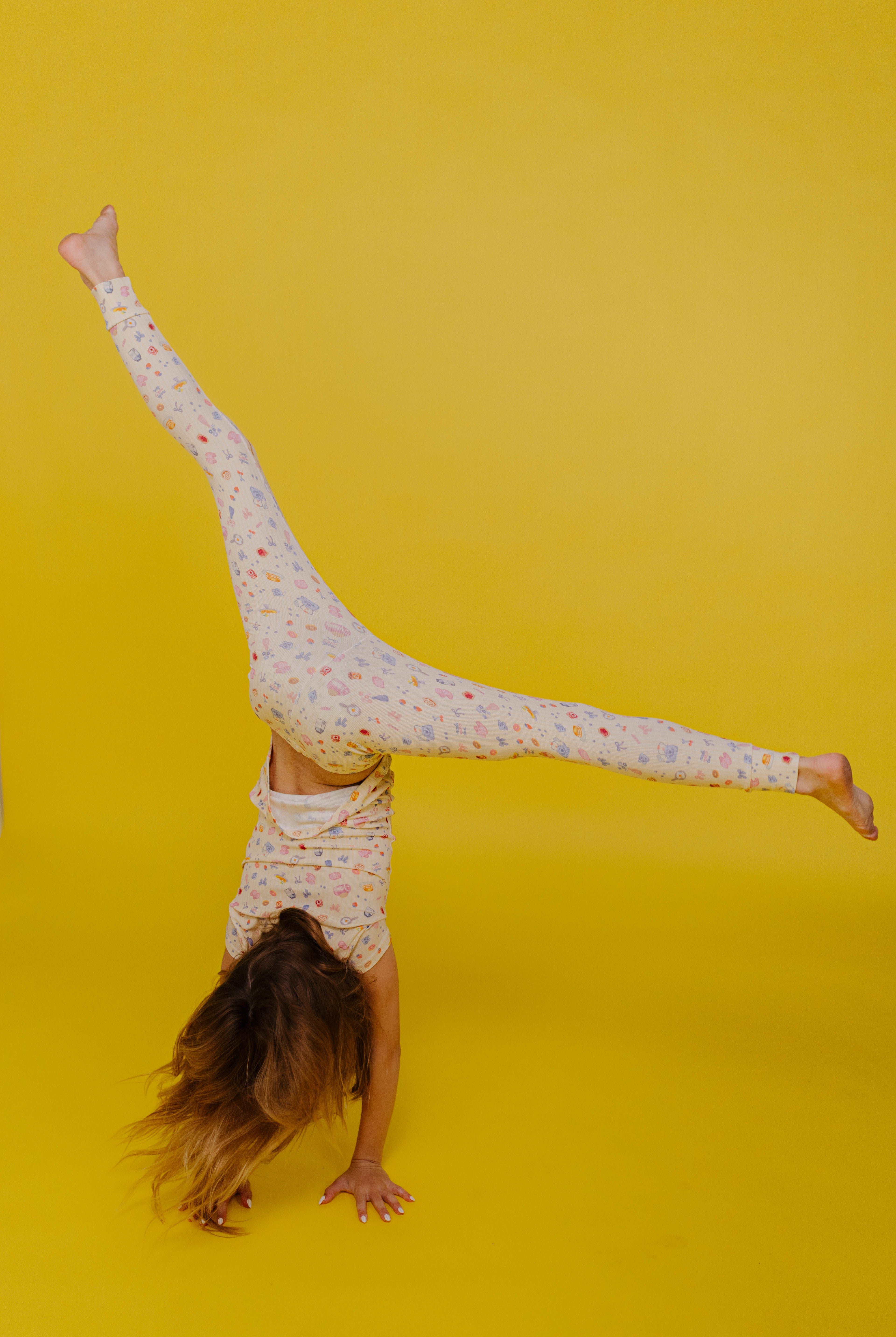 Kolly doing a cartwheel on yellow background