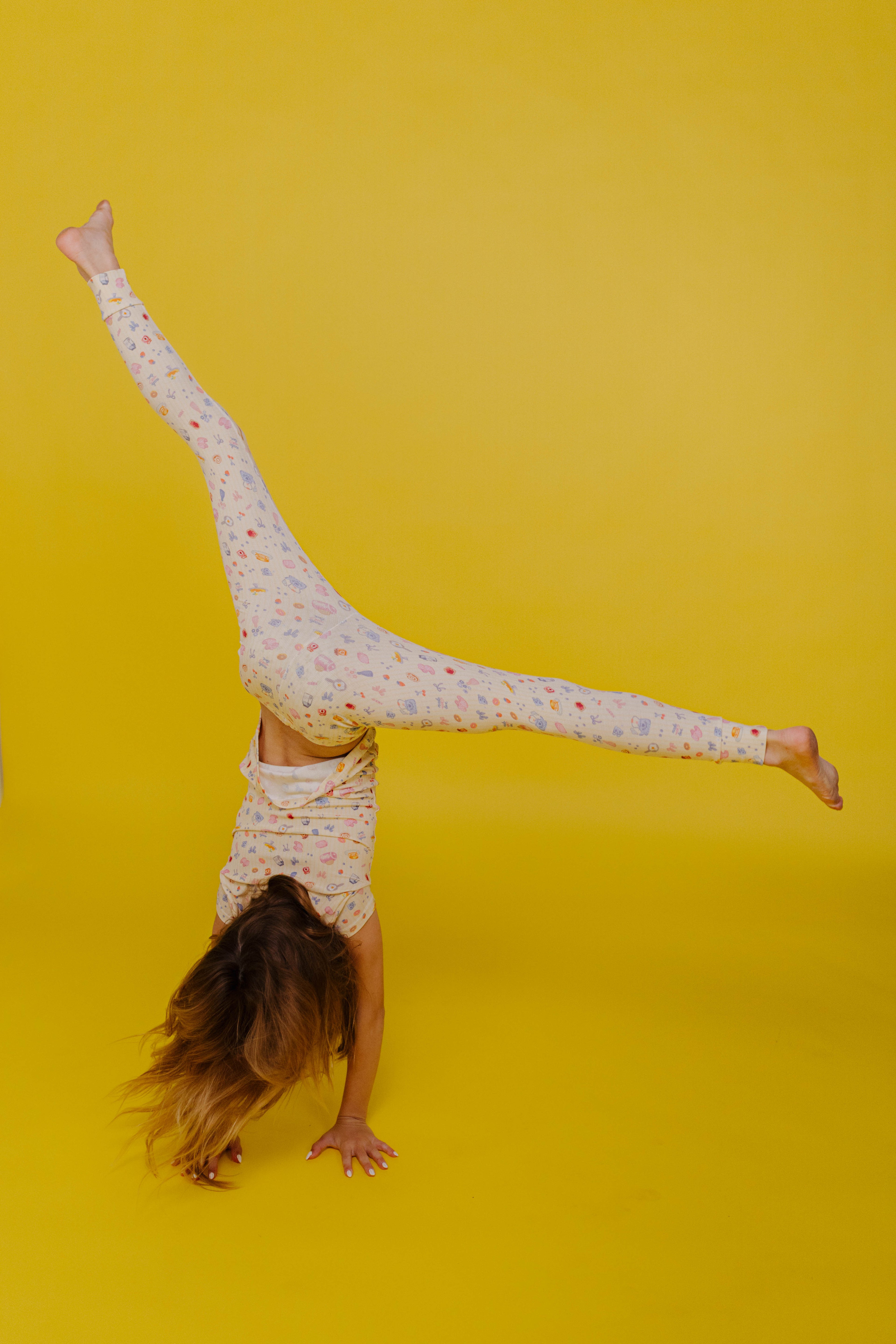 Kolly doing a cartwheel on yellow background
