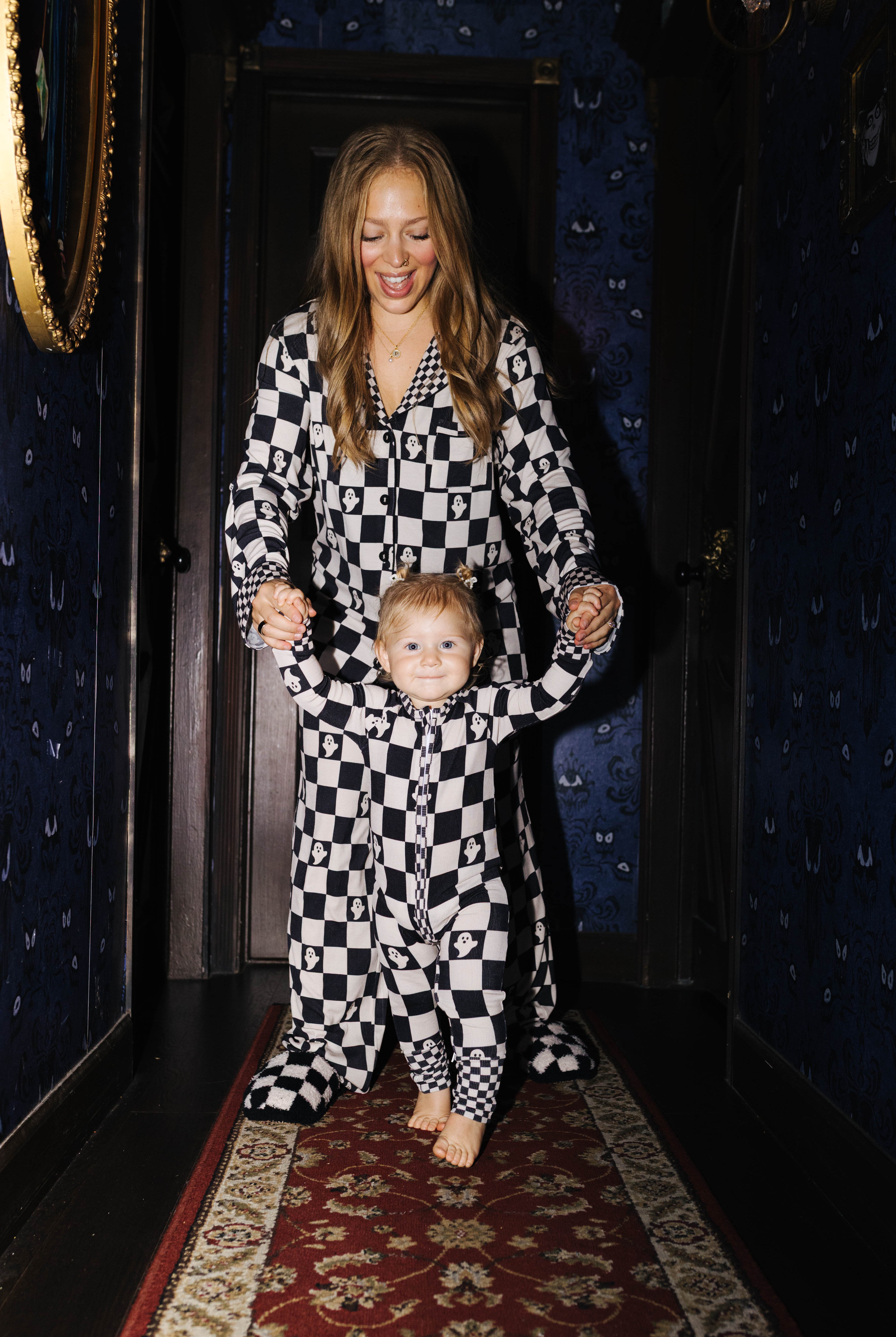Adult and baby wearing matching Ghost Check pajamas