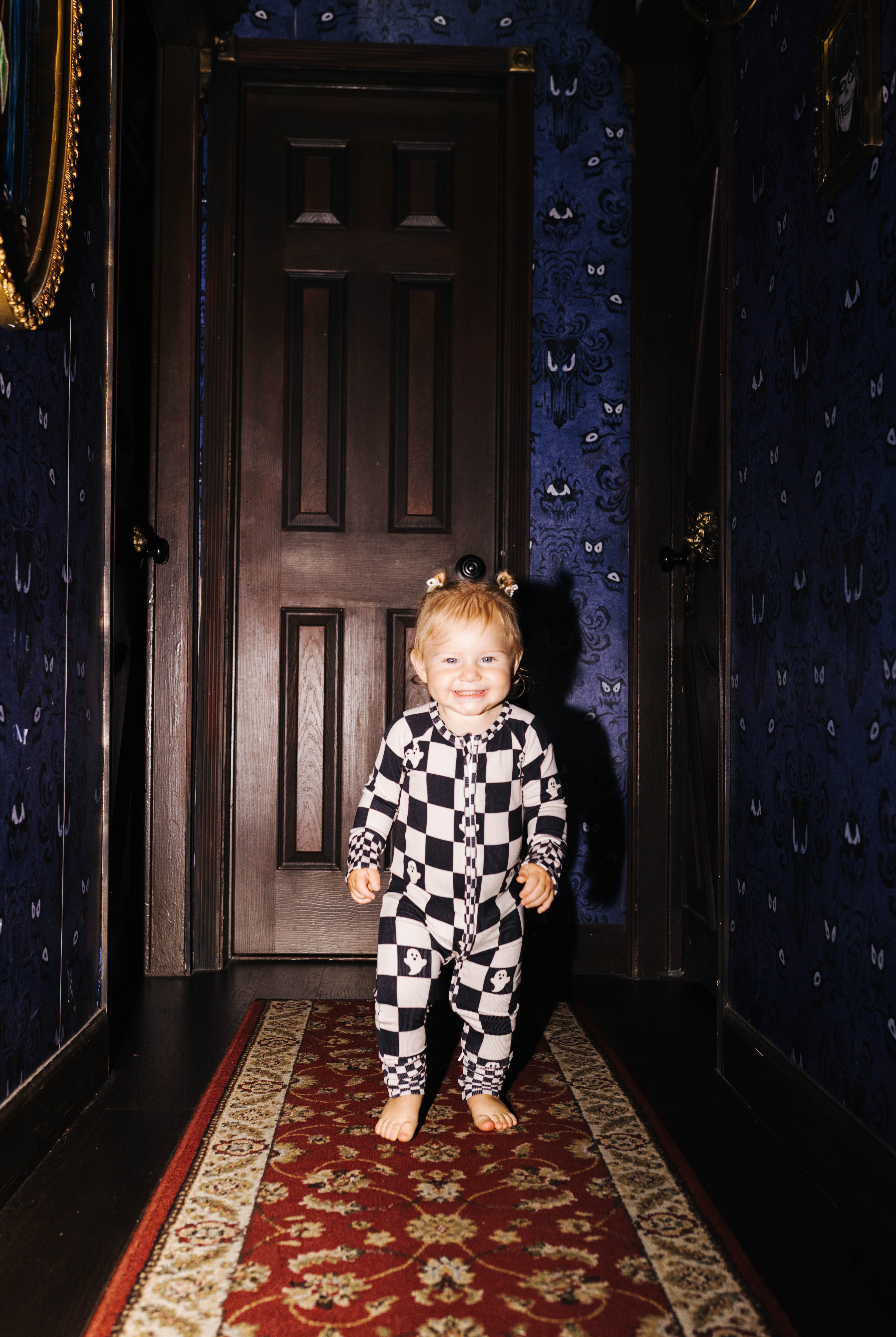 Front view of baby Ghost Check zip pajamas