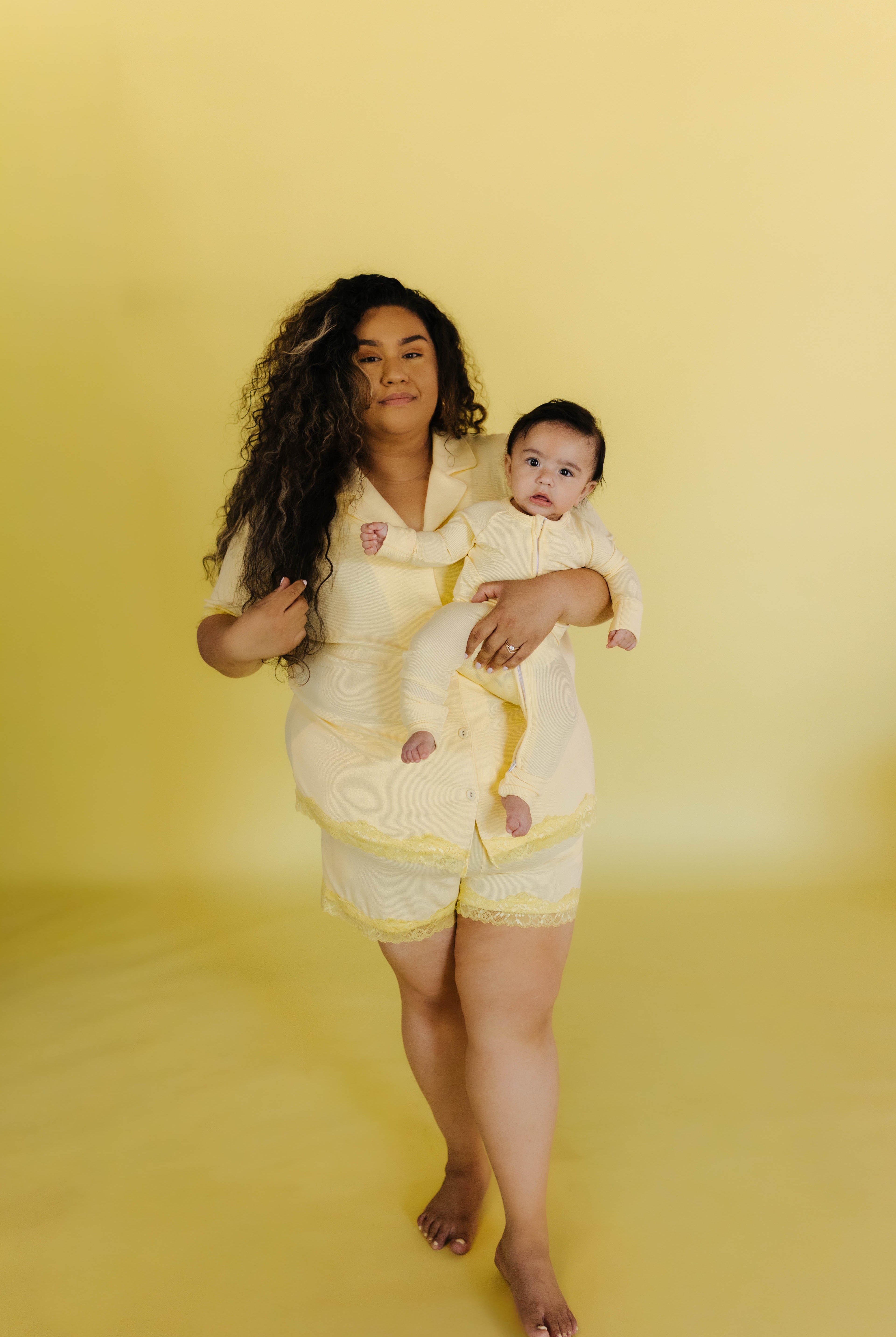 Perla in the 3xl holding her son in the baby pjs