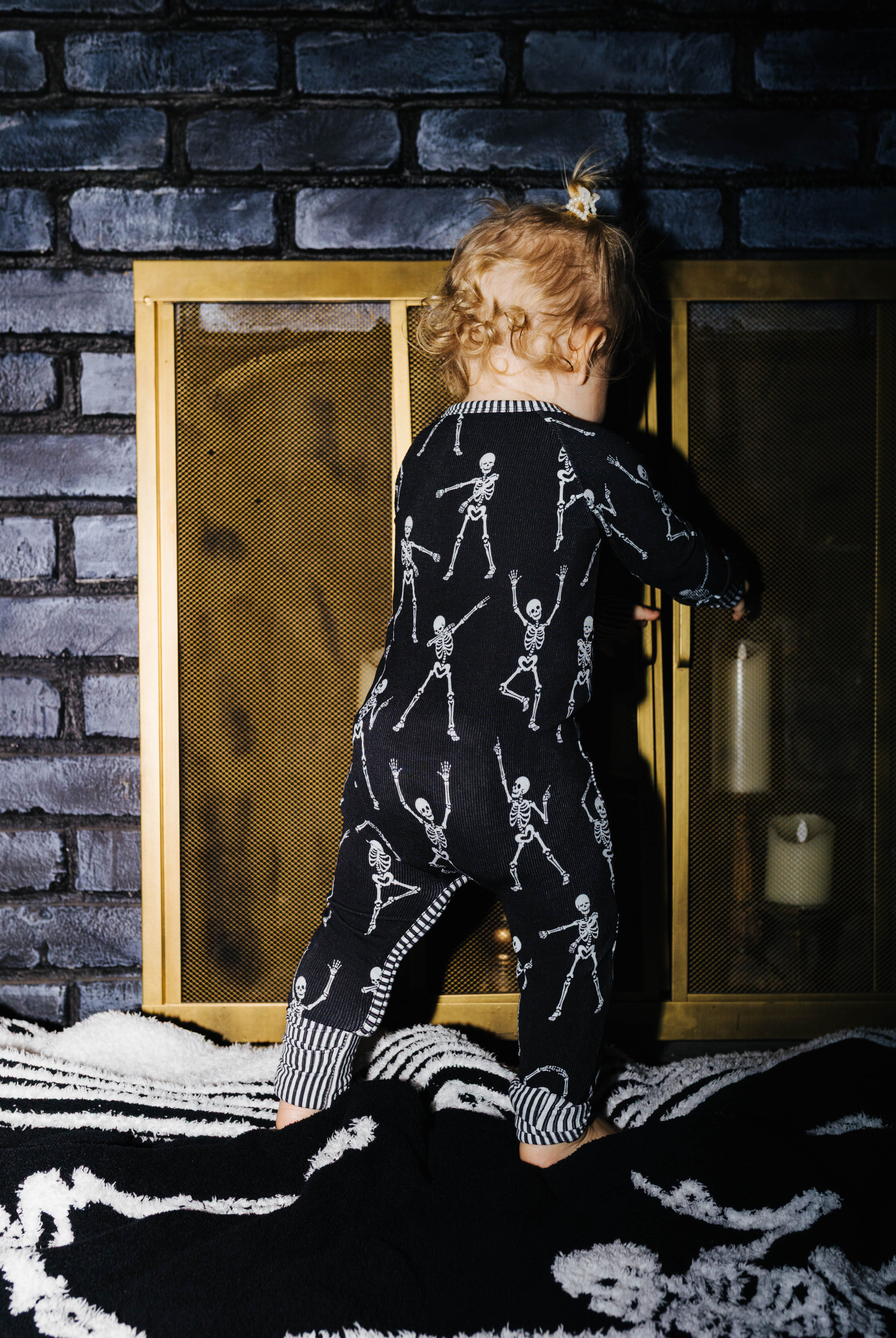 Back view of baby Skelly zip pajamas