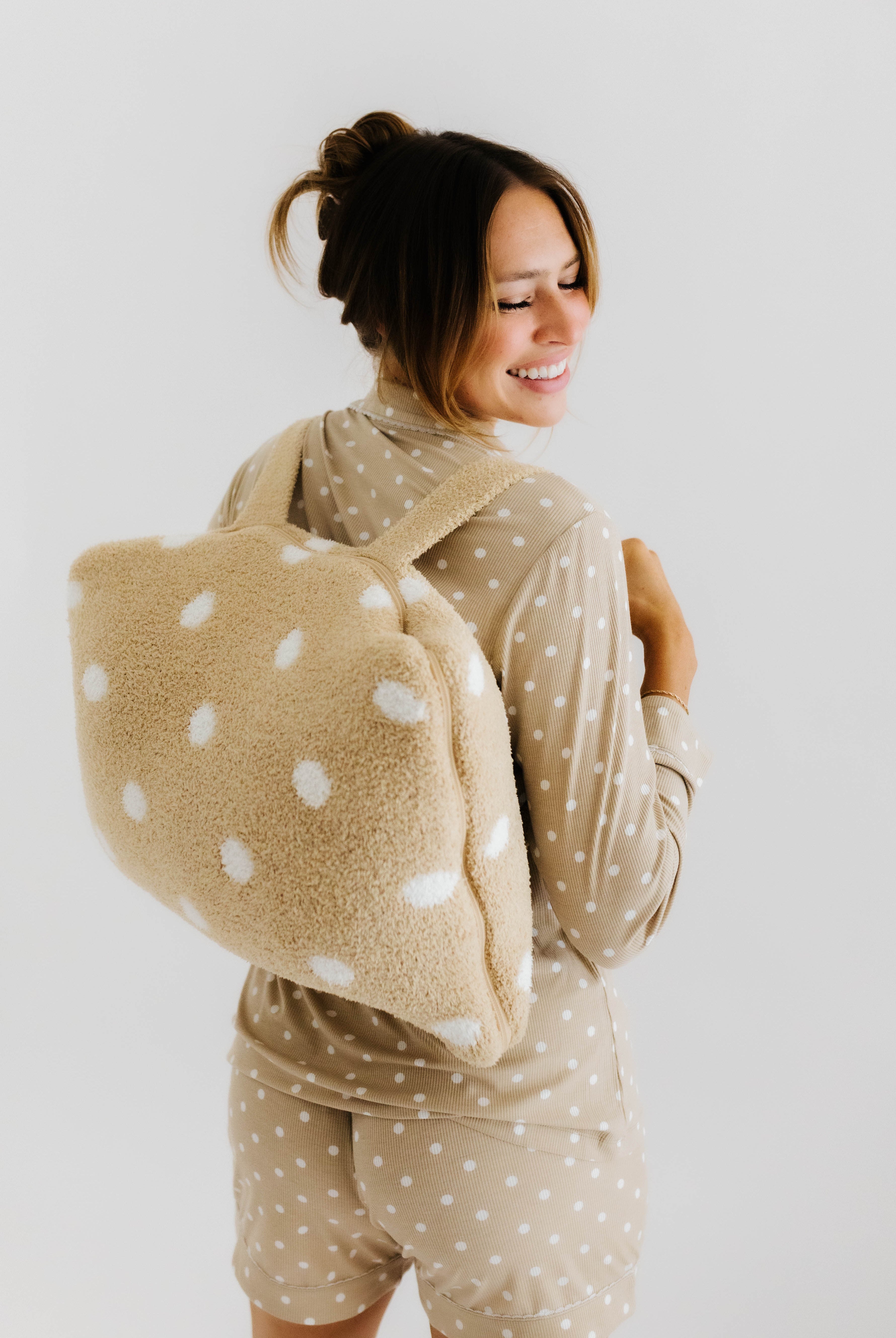 model bri wearing lace polka dot pajamas with polka dot quillow on back