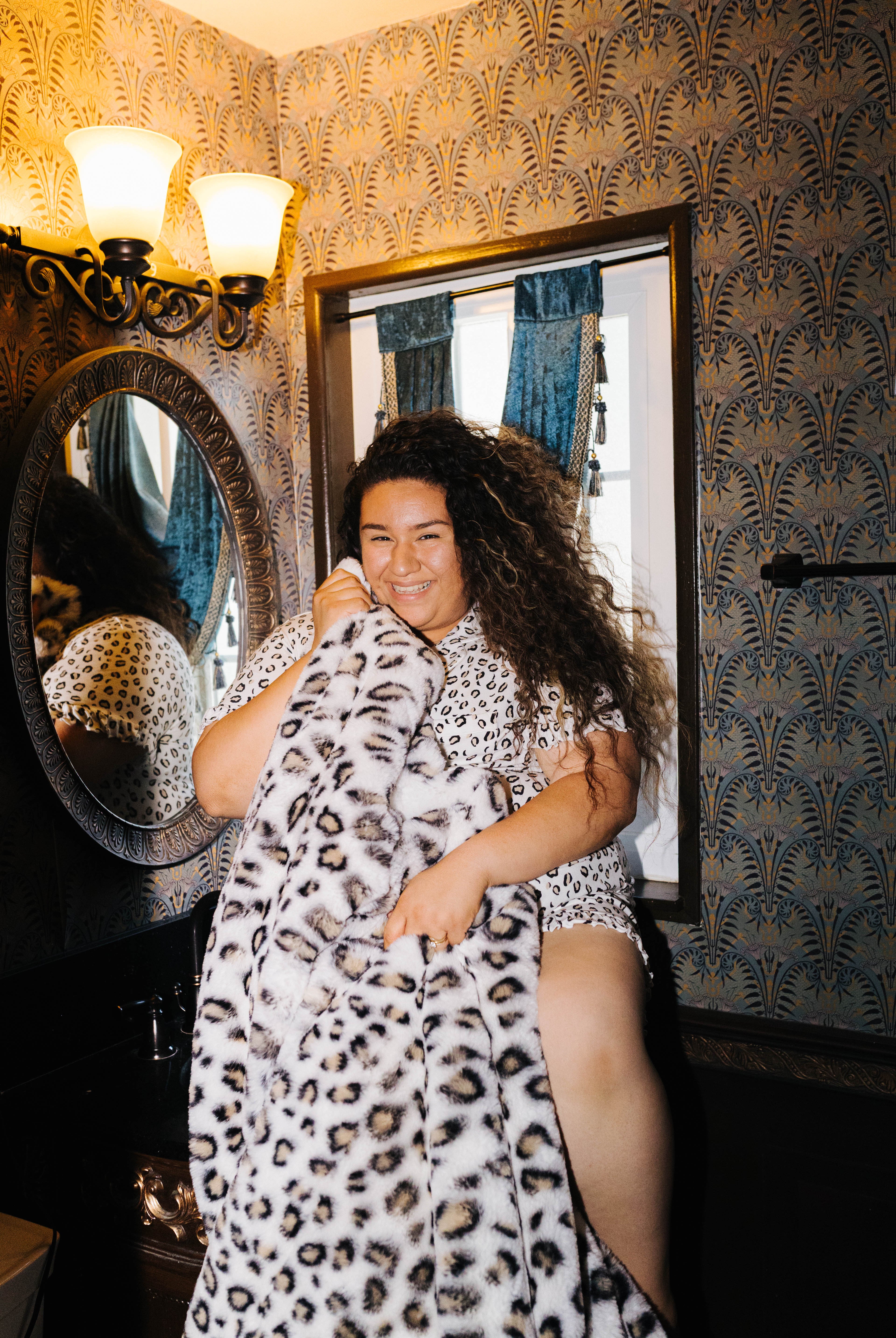 Model holding the leopard blanket in front of her