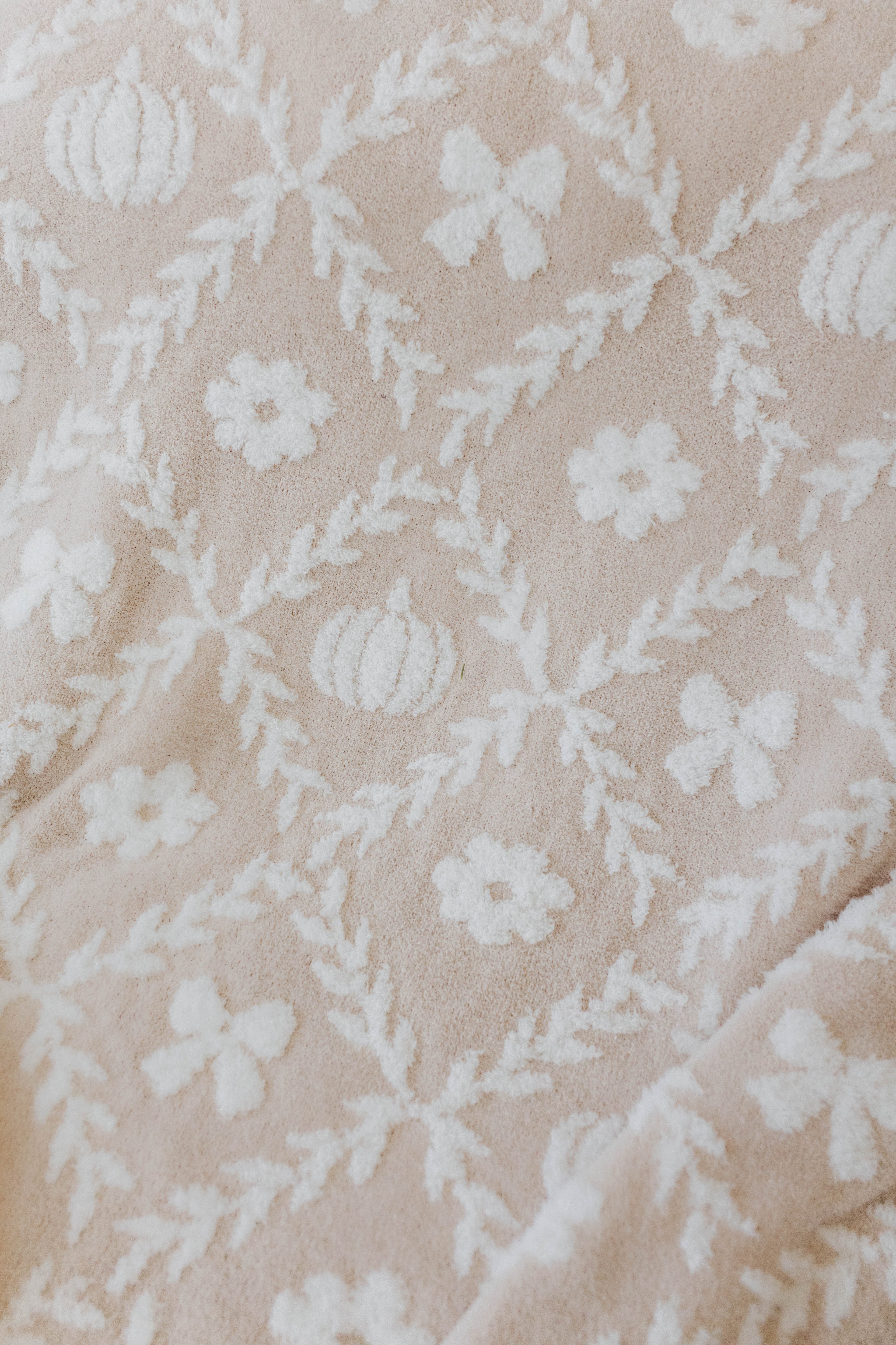 close up of the pumpkin blanket print with pumpkins, flowers, and bows