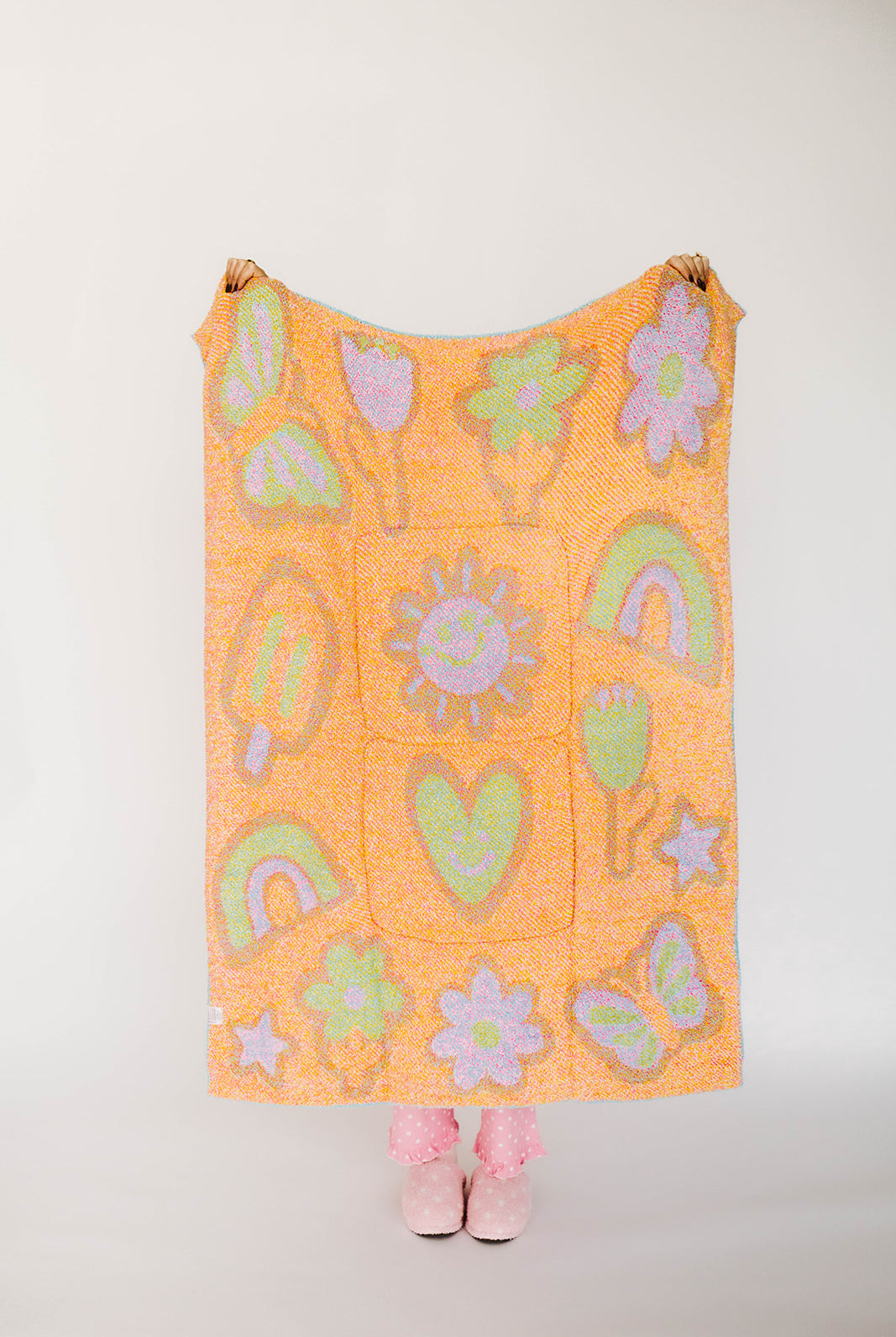 Orange blanket with colorful patterns on a white background