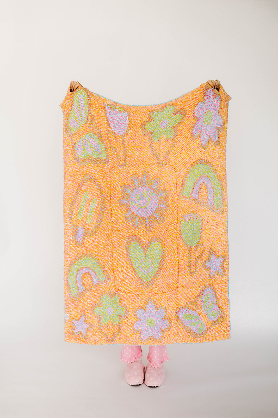 Orange blanket with colorful patterns on a white background