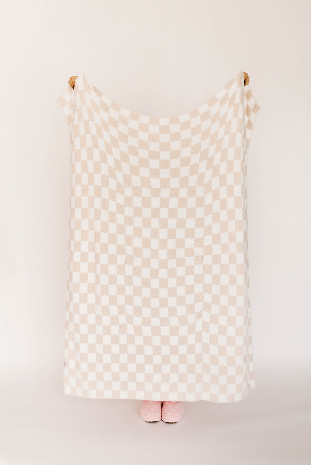 Checkered blanket against a white wall