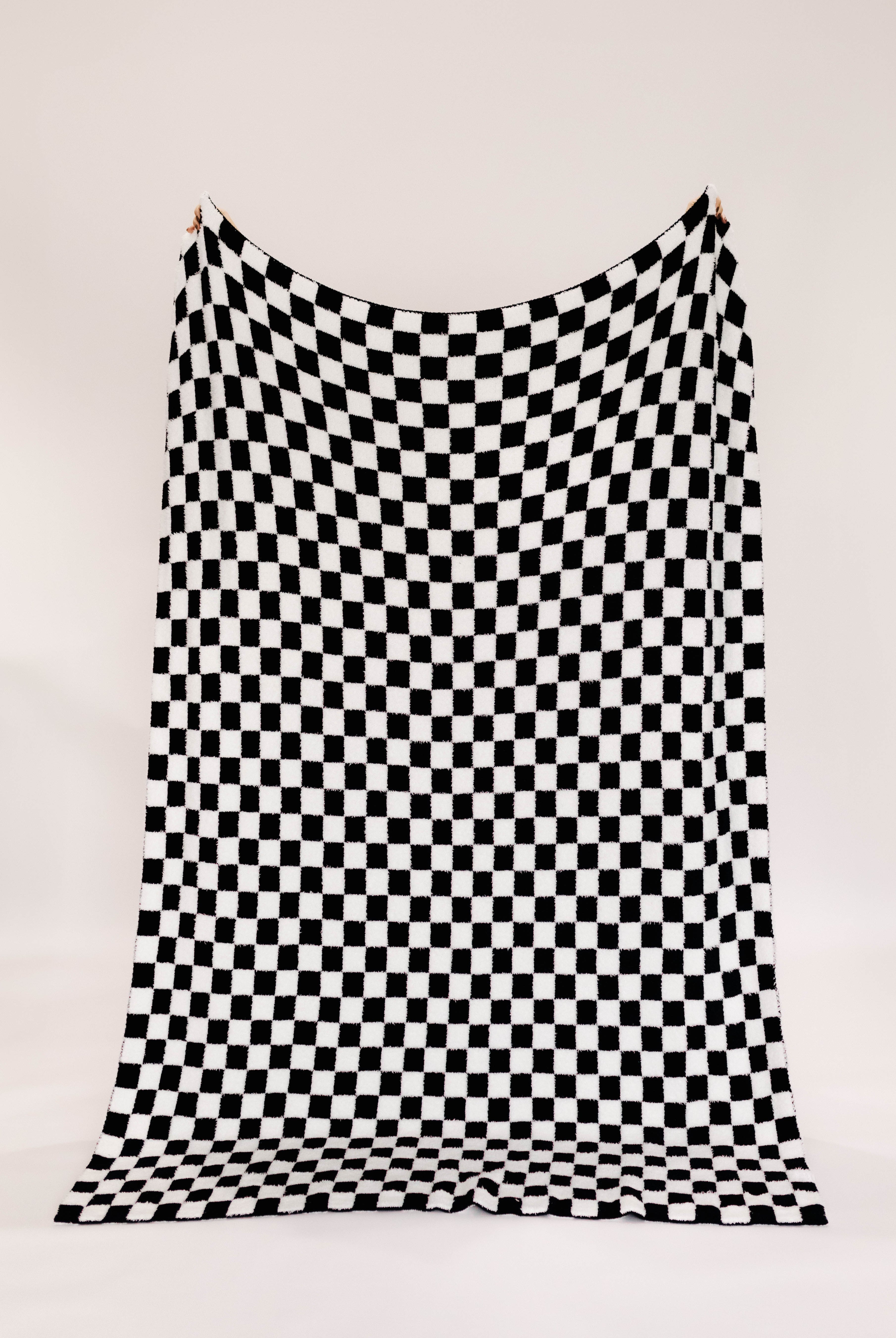 Black and white checkered blanket on a white background