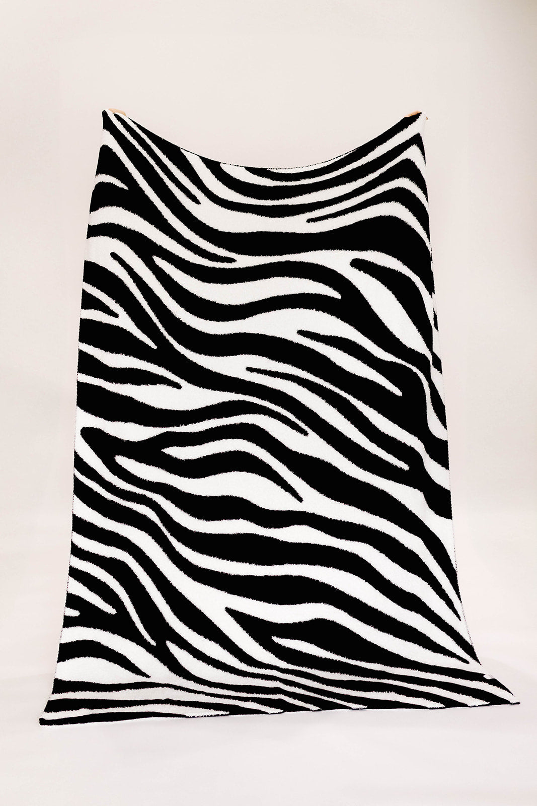 Black and white zebra-striped fabric on a white background