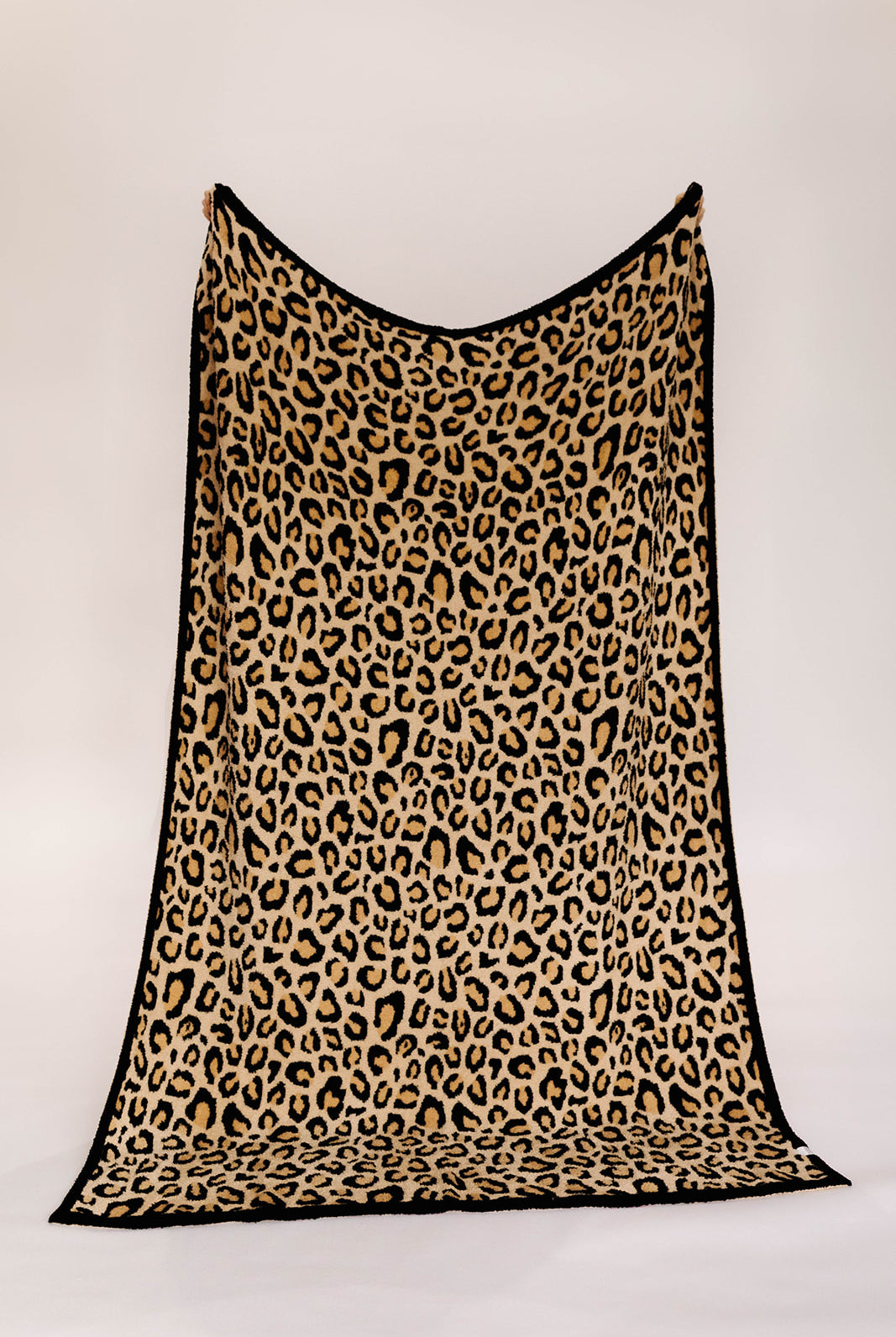 Leopard print blanket on a white background