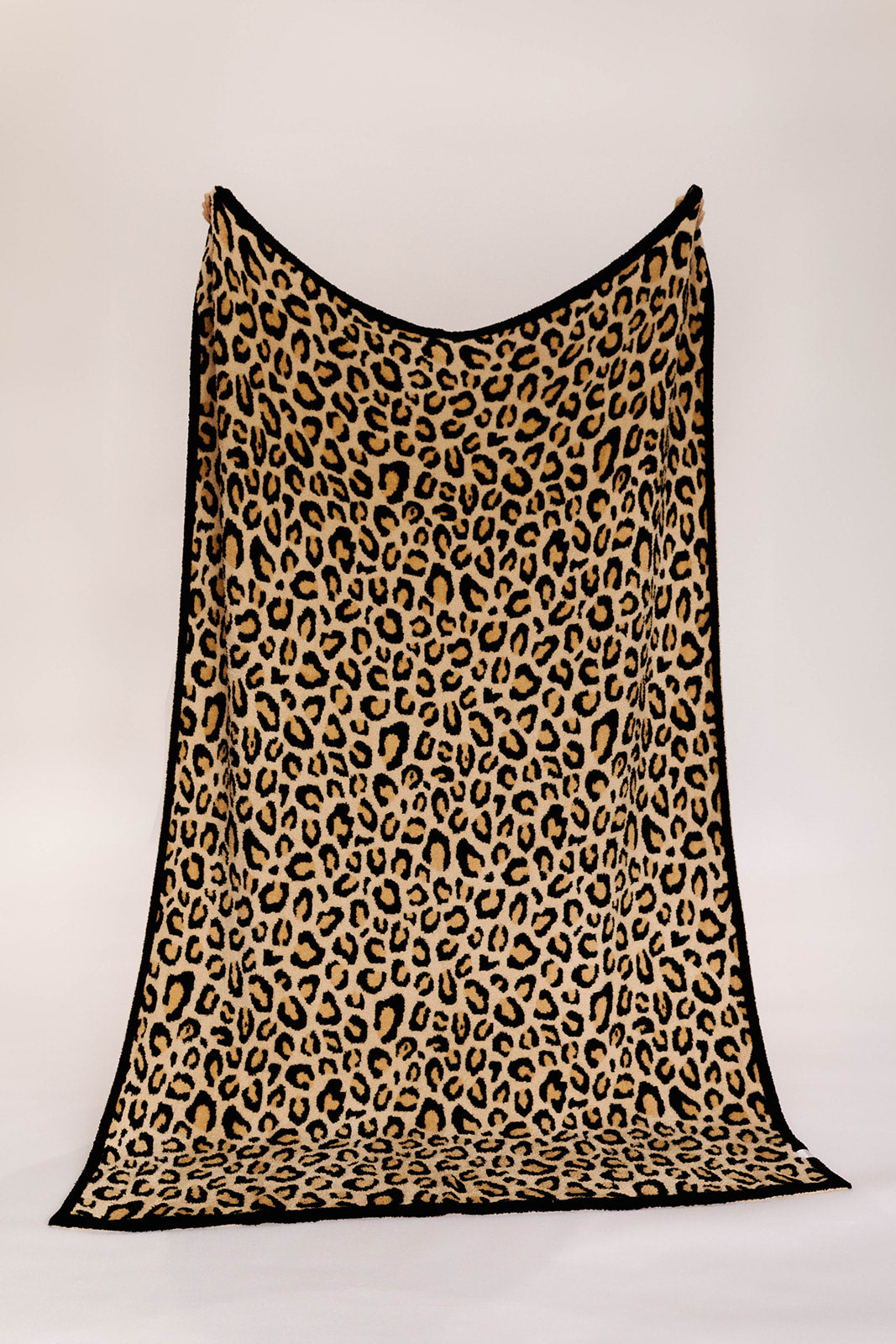 Leopard print blanket on a white background