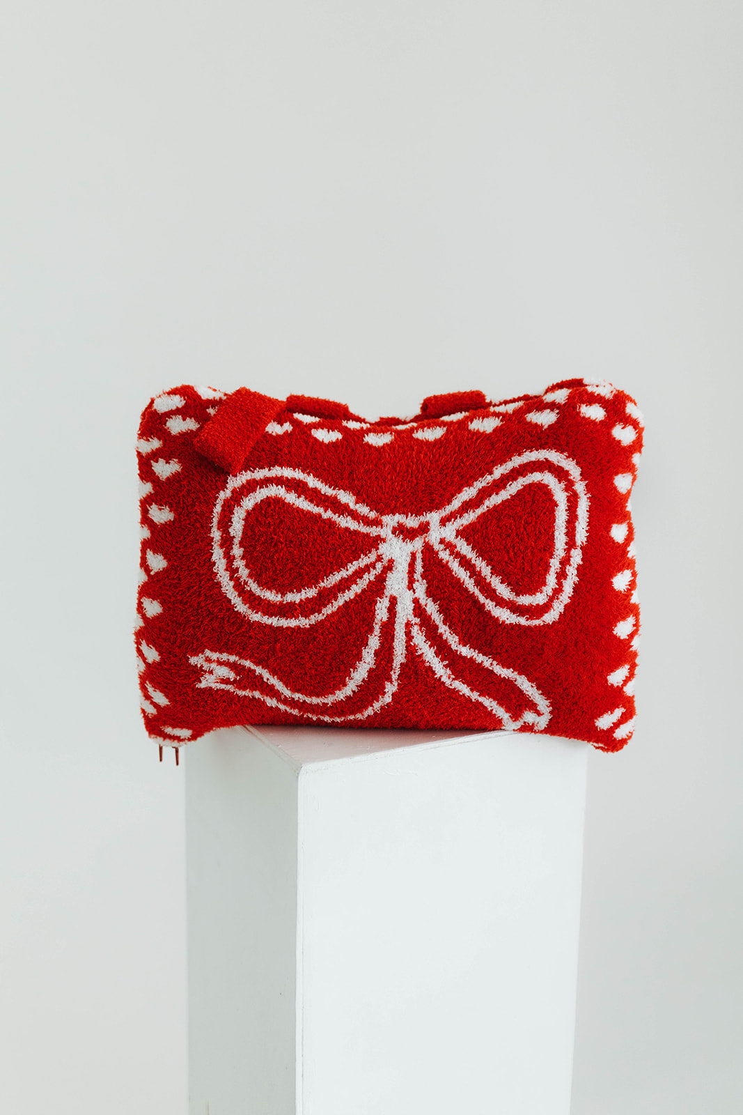 Red quillow with white bow design on a white background