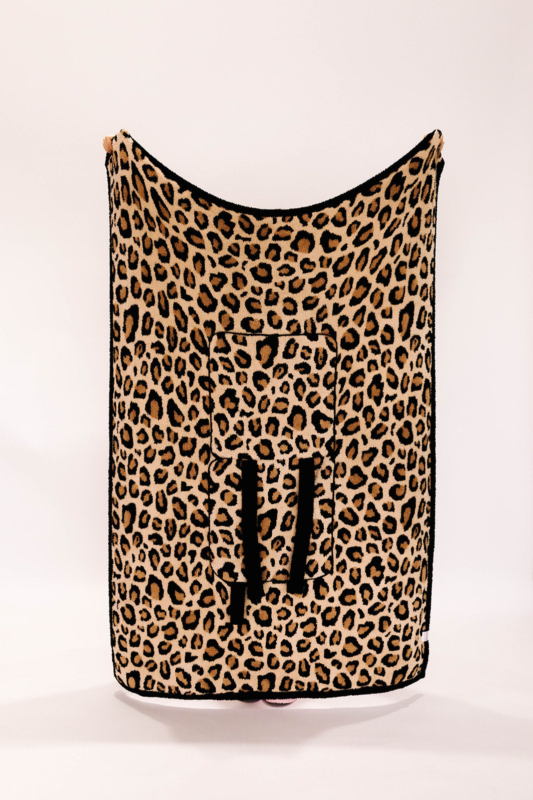 Leopard print blanket against a white background