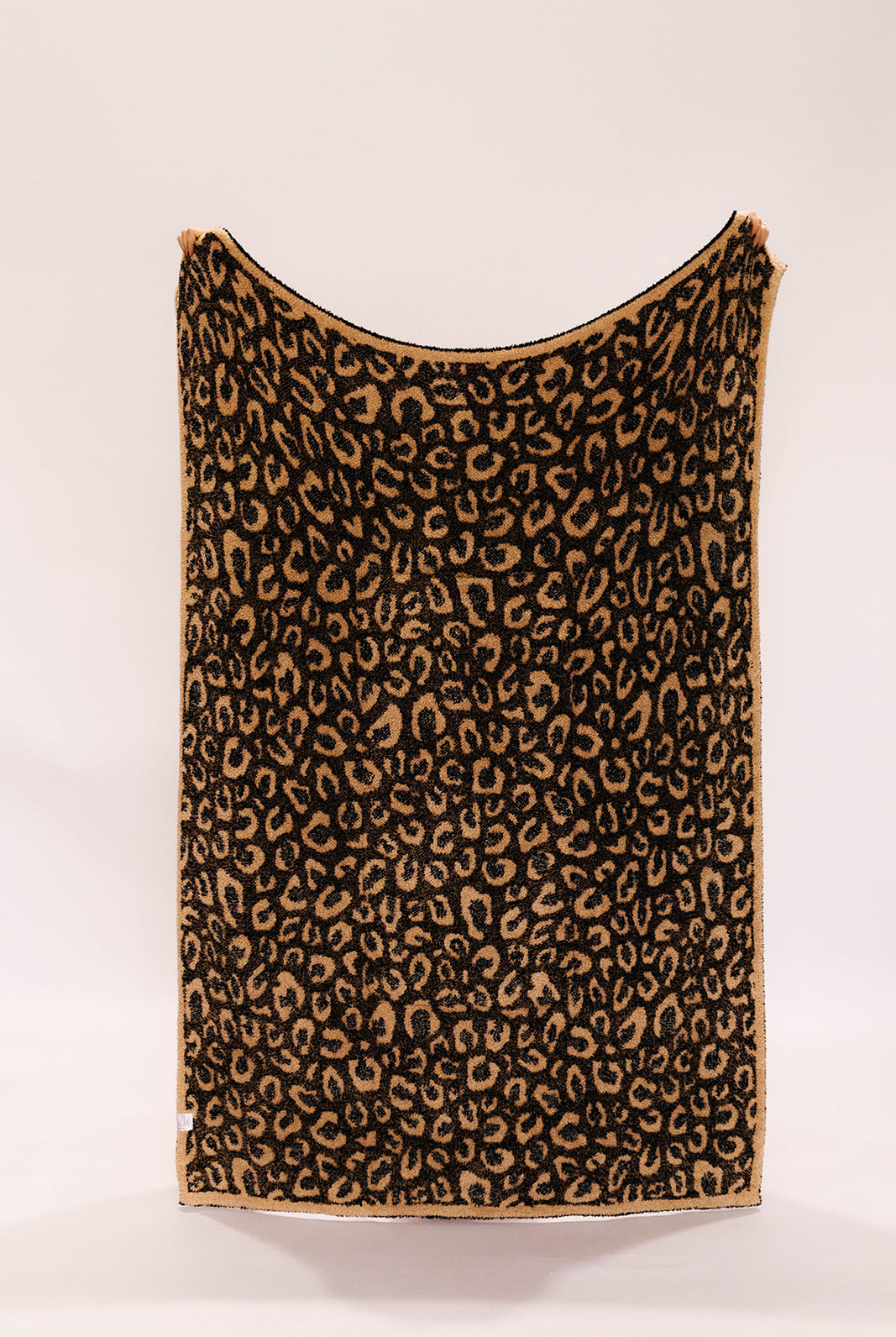 Leopard print blanket on a white background