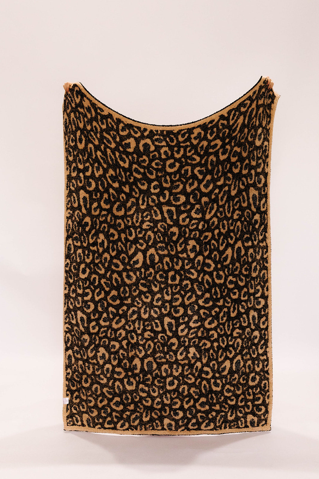 Leopard print blanket on a white background