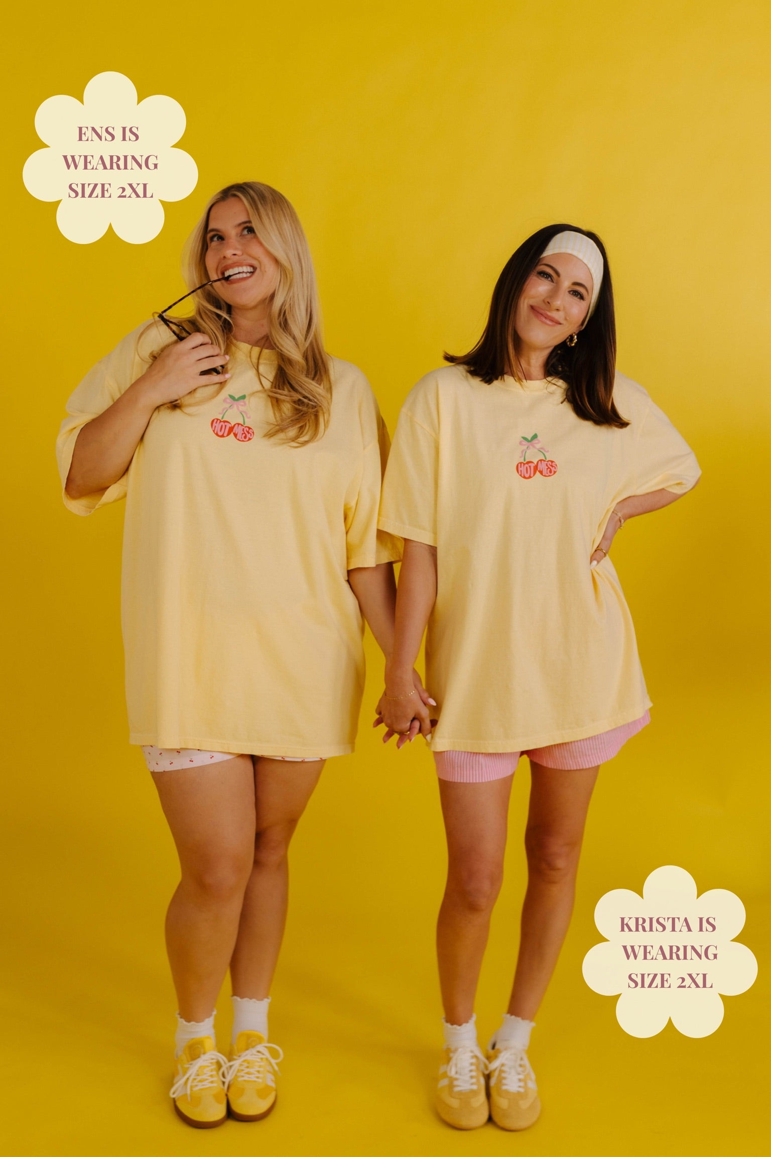 Two women wearing matching yellow oversized t-shirts on a yellow background