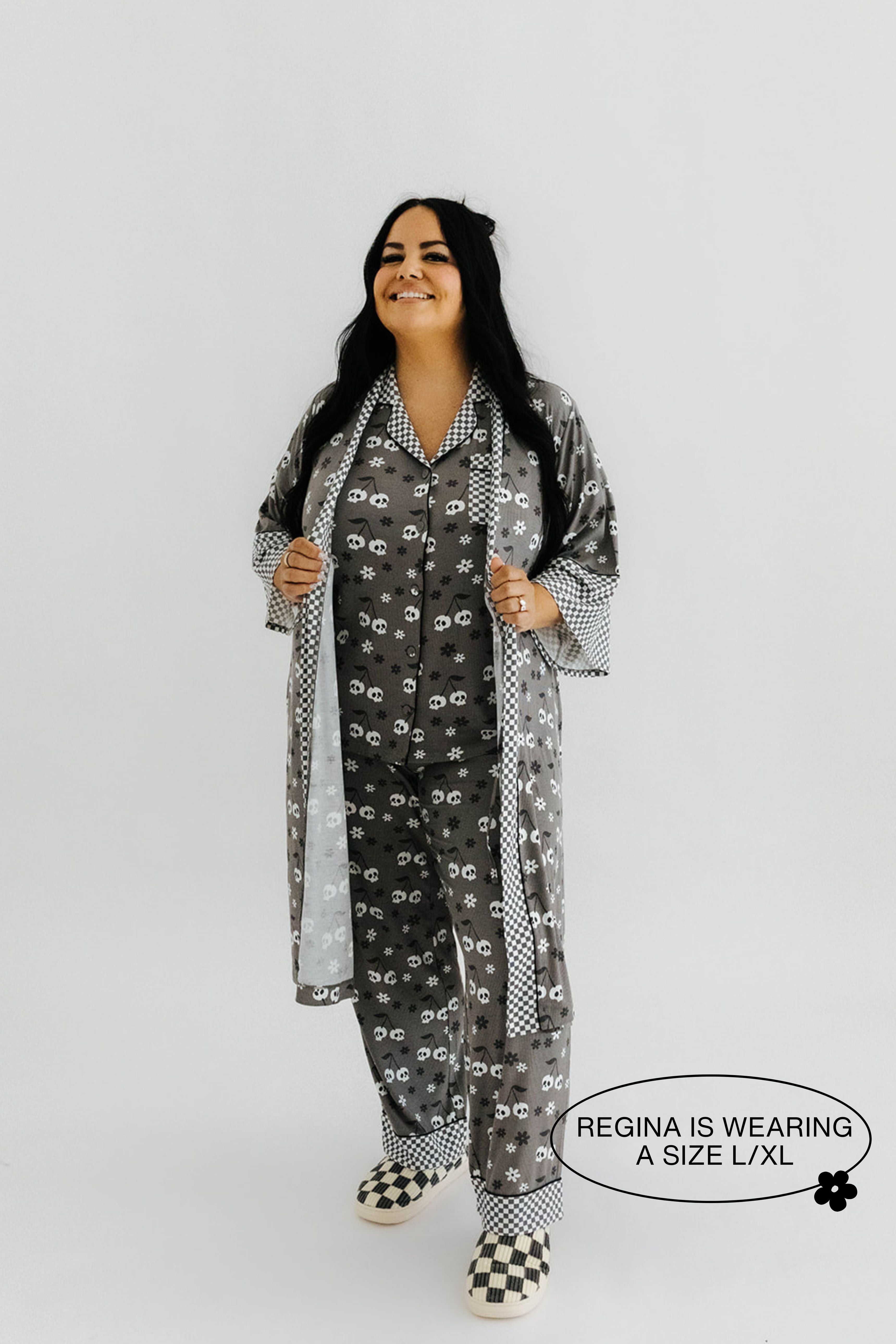 model regina wearing the size extra large in the skeleton pajamas and robe