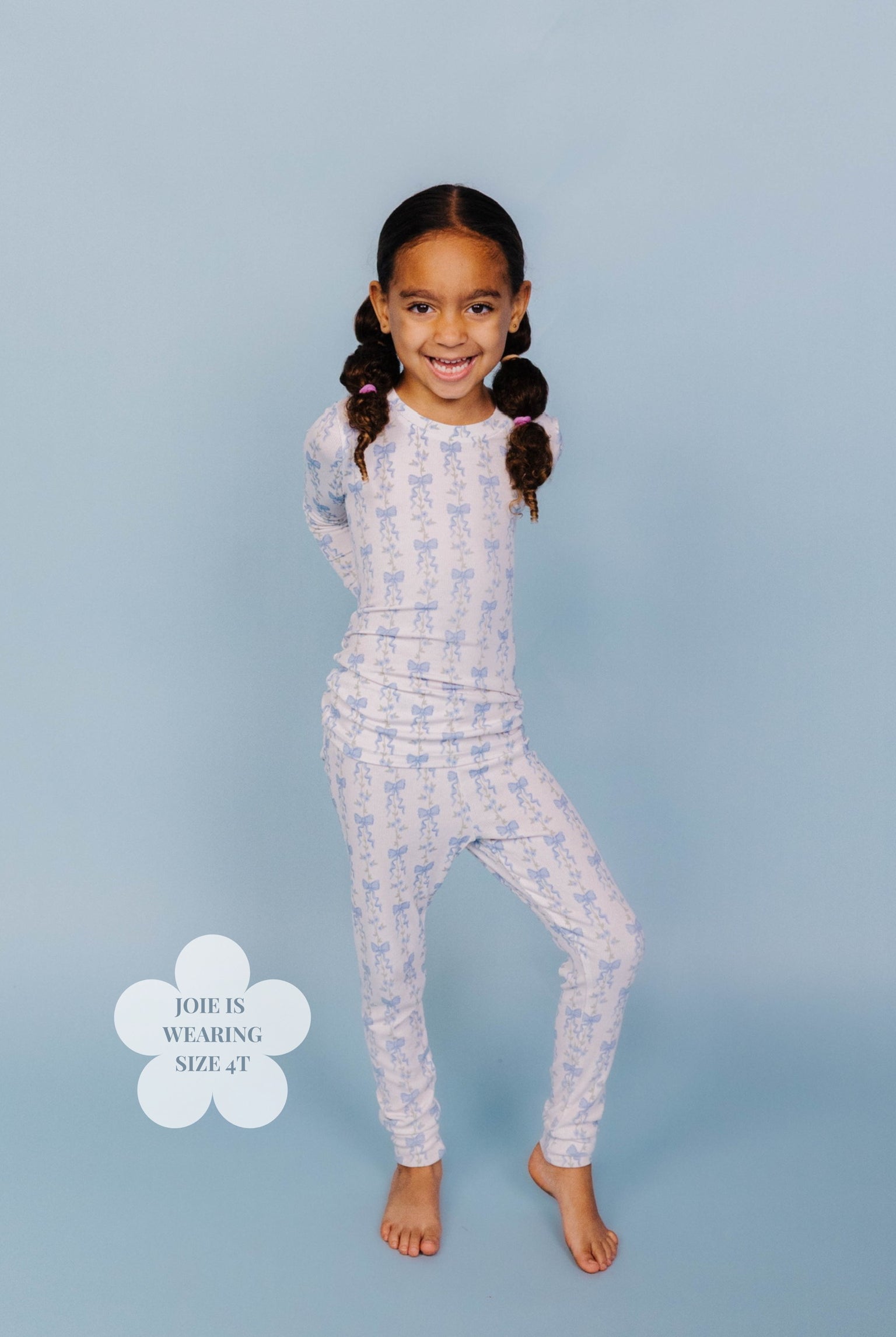 Showing the blue bow pjs on a 4t girl