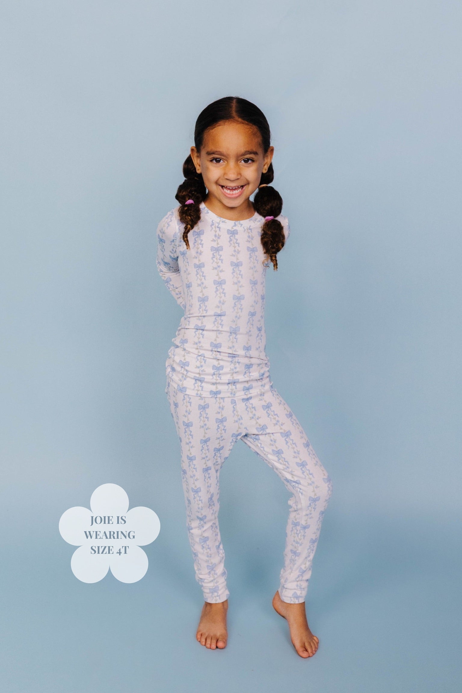 Showing the blue bow pjs on a 4t girl