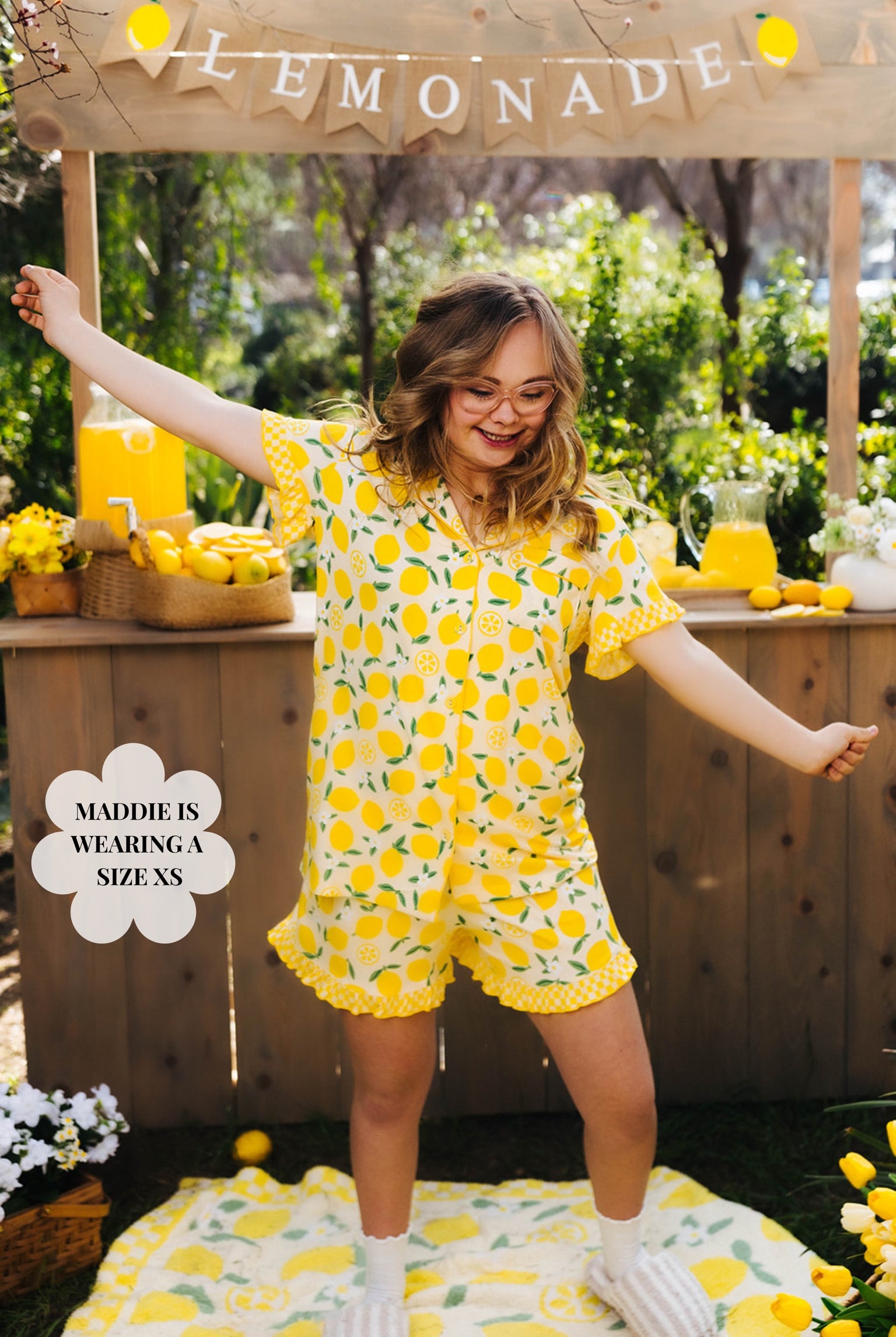 Maddie posing in the XS pjs in front of the lemonade stand and dancing