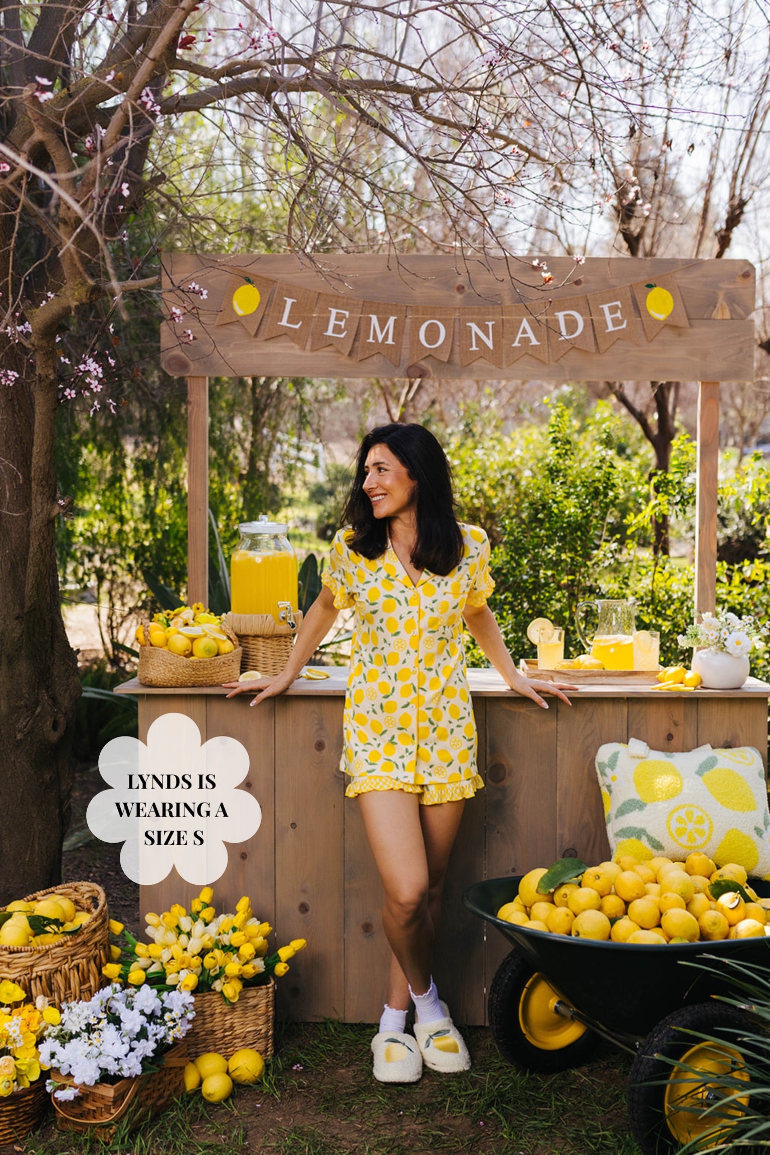 Lynds posting in the small pjs in front of the lemonade stand