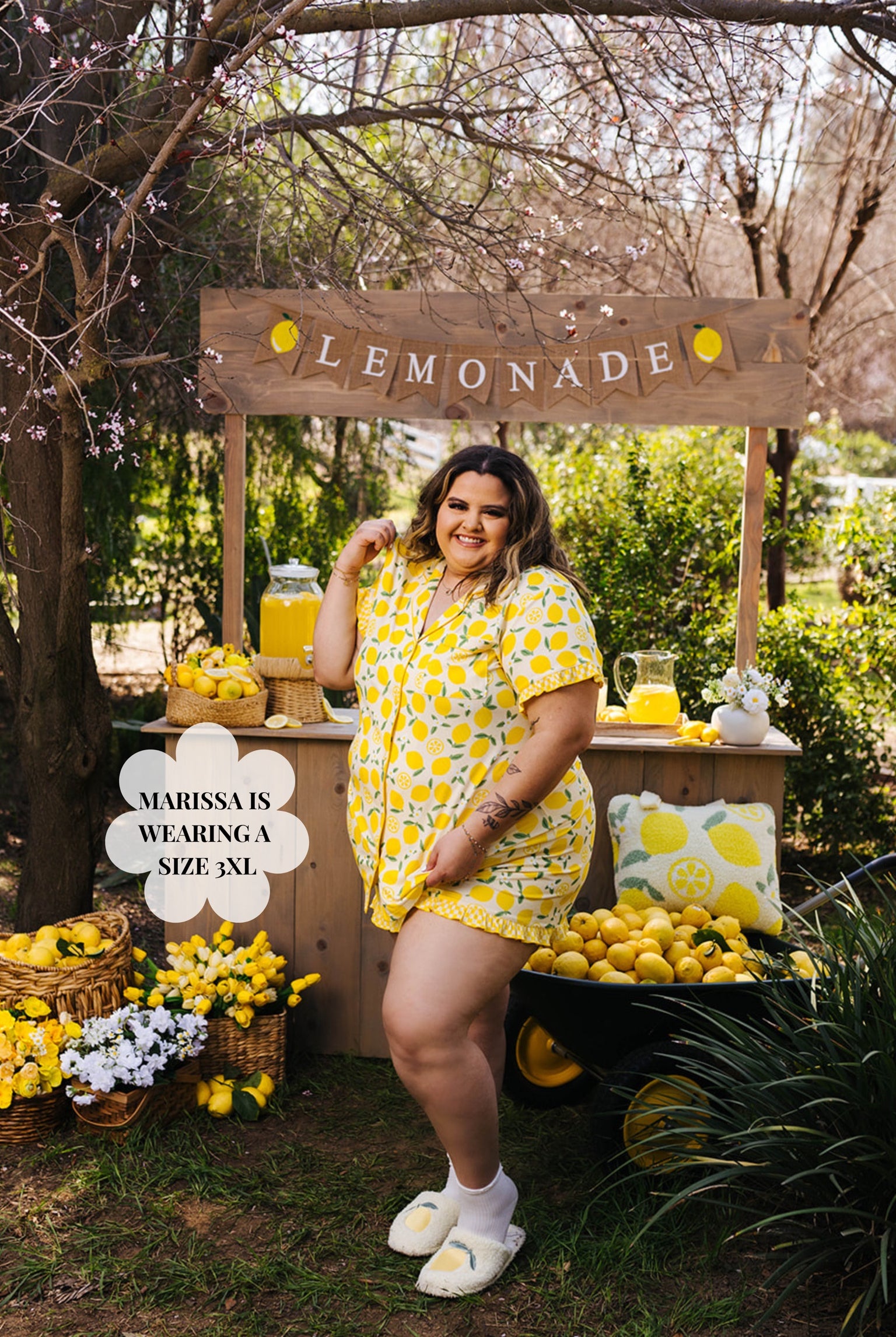 Woman in a yellow outfit standing next to a lemonade stand with lemons and a 'Lemonade' sign.