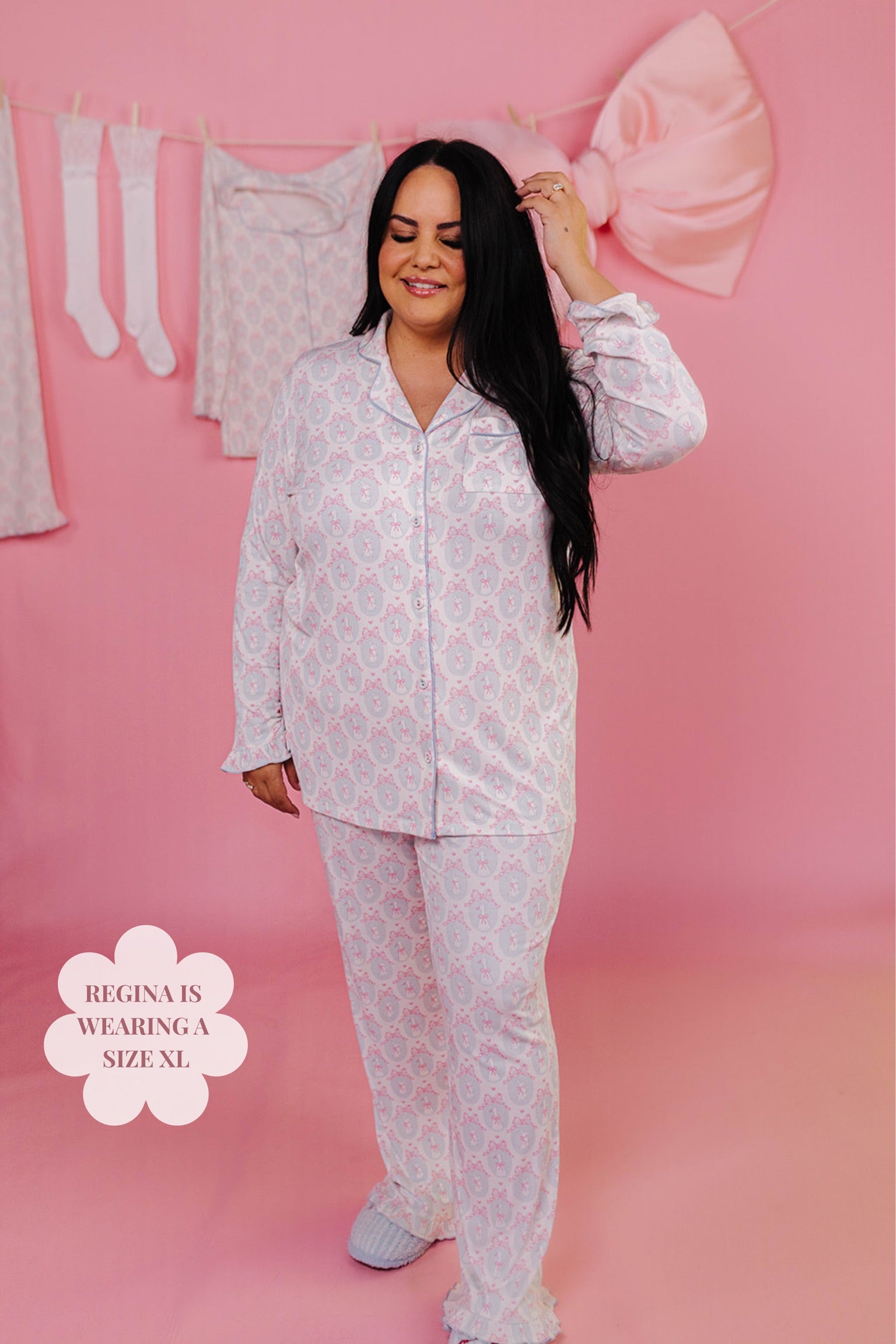 Woman wearing a white pajama set on a pink background with text indicating size XL.