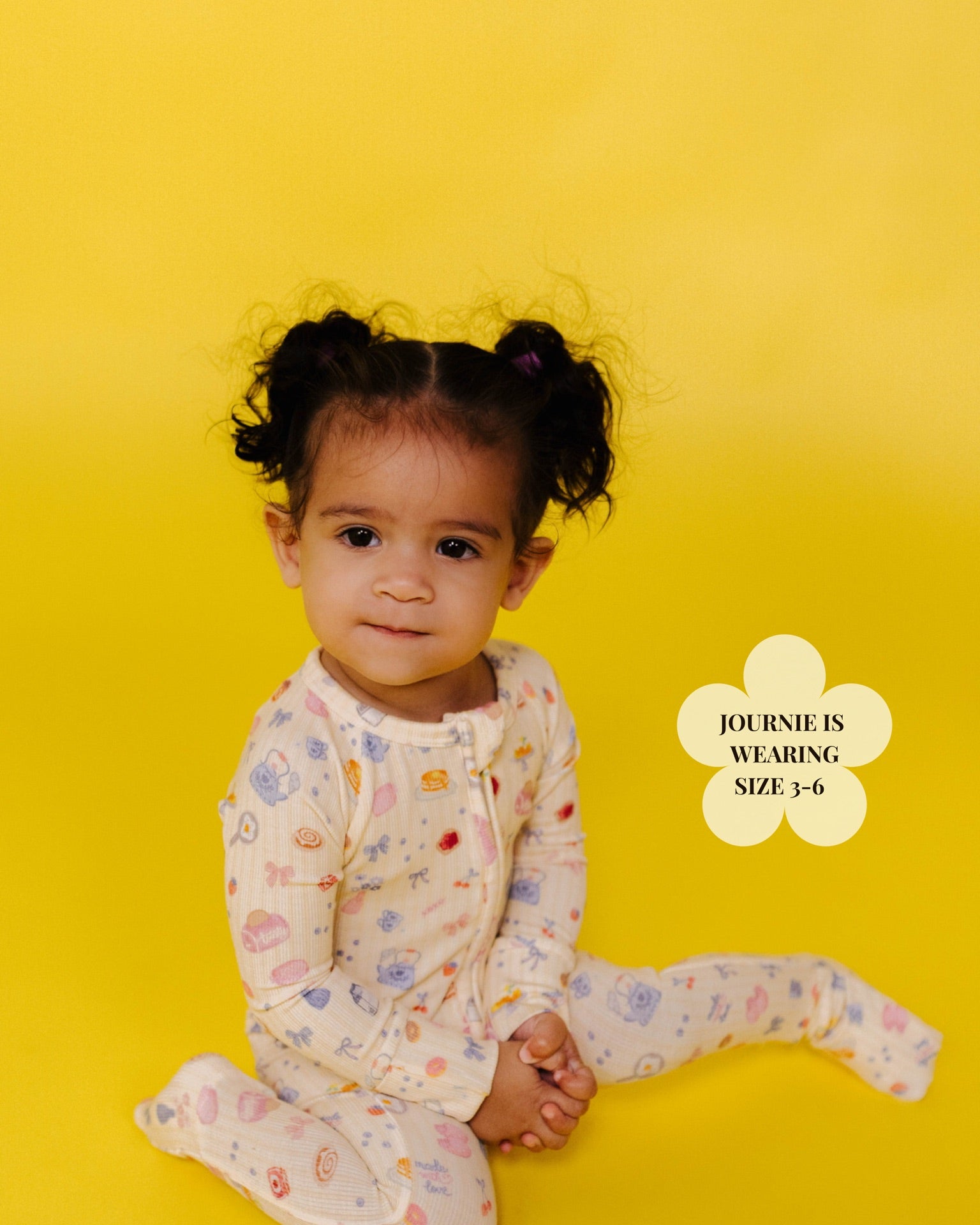 Child wearing a brunch onesie on a yellow background