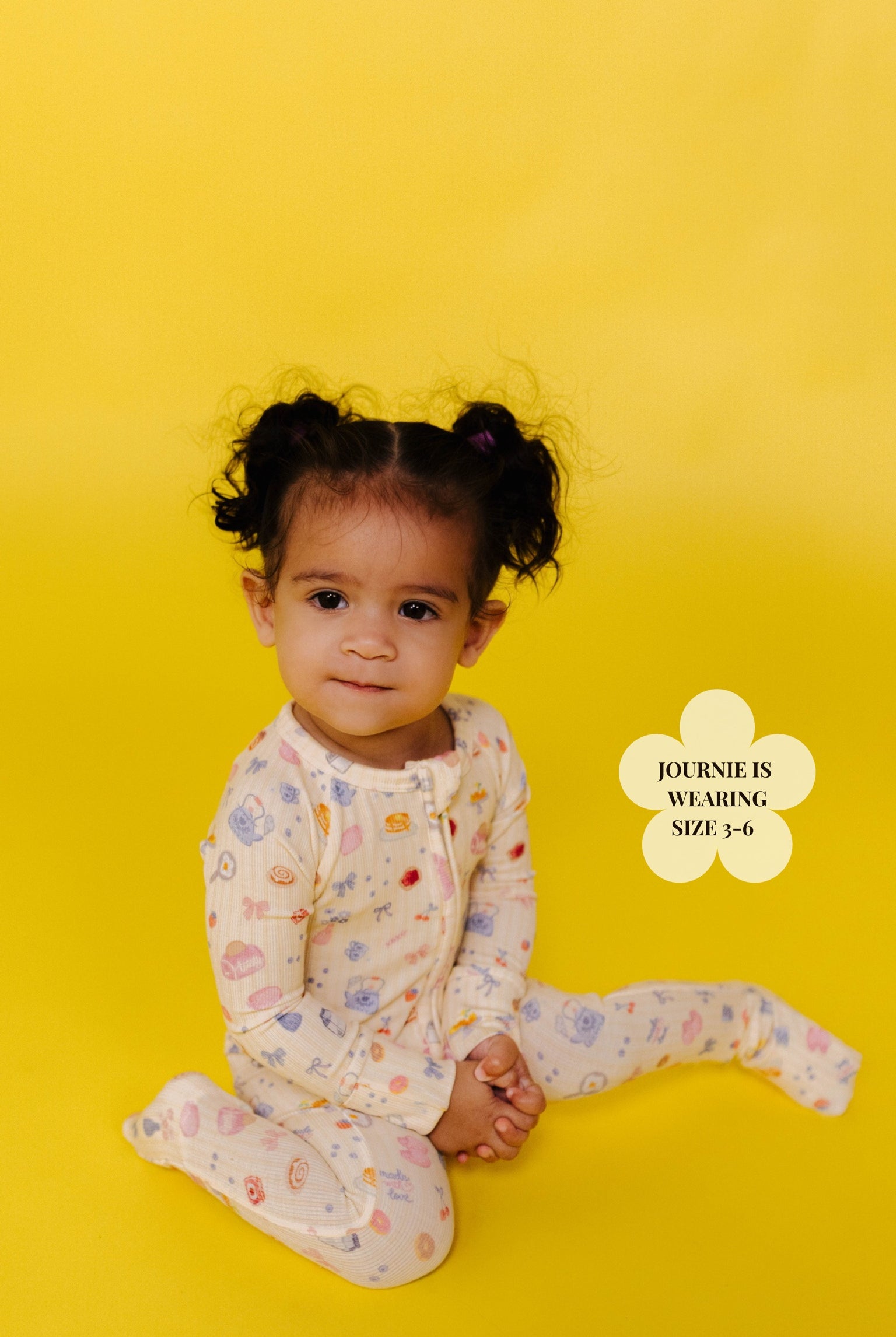 Child wearing a brunch onesie on a yellow background