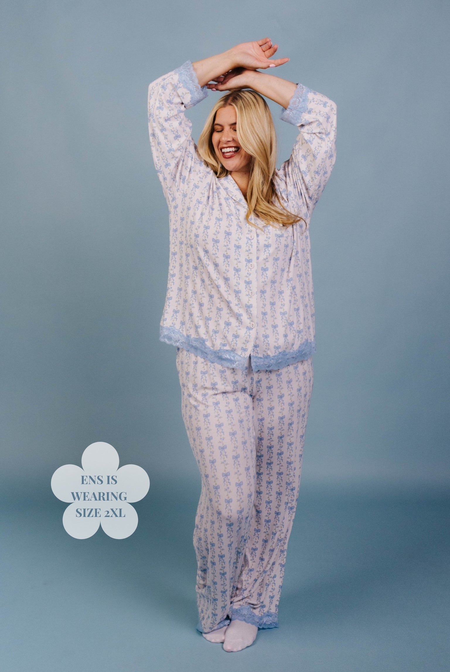 Woman wearing a patterned pajama set against a blue background size 2xl