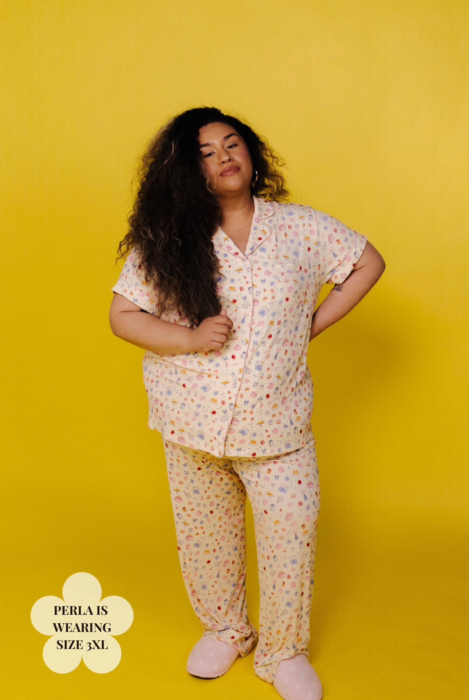 Perla in a size 3xl brunch pj against a yellow background