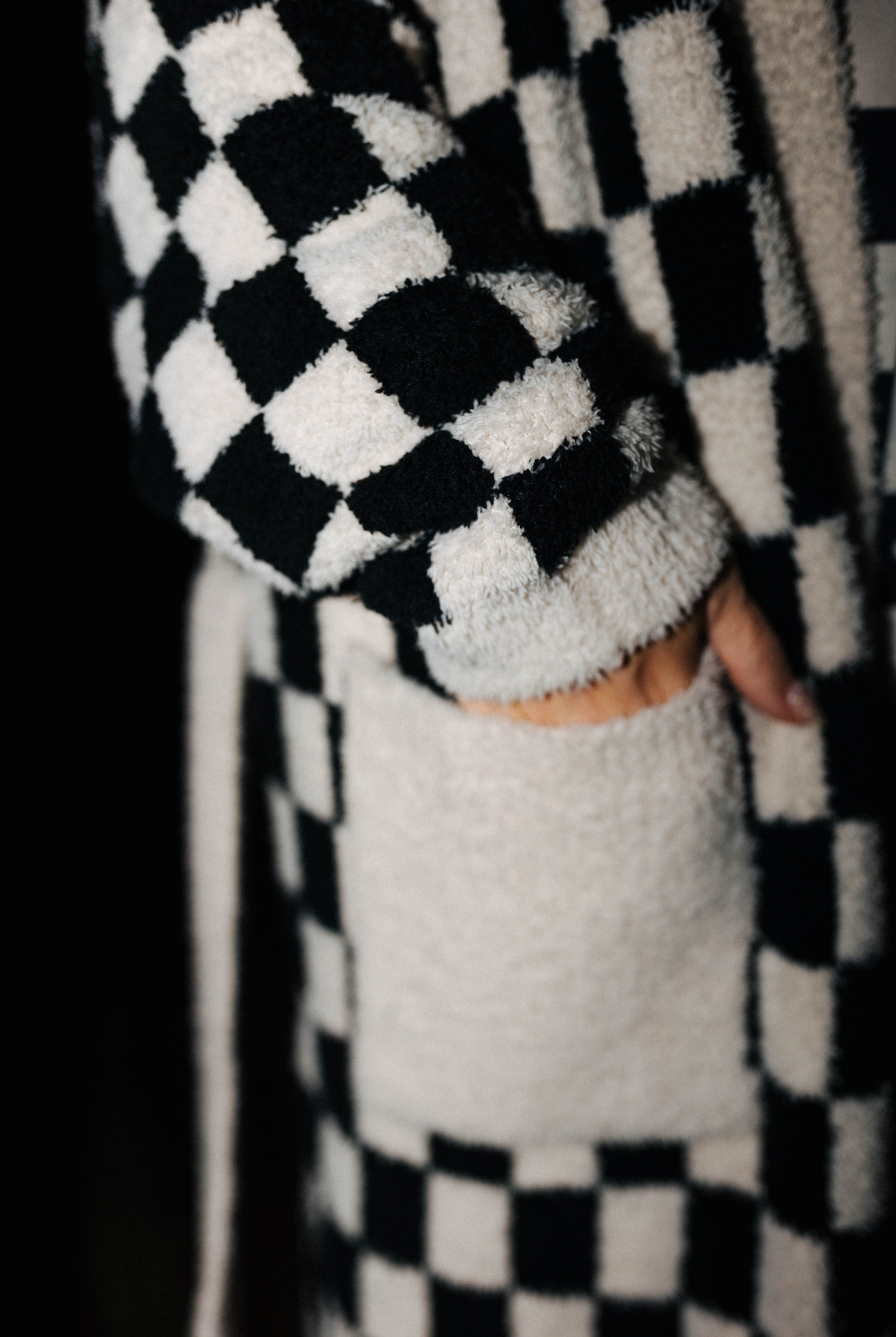Close view of the fluffy check robe cuff and pocket