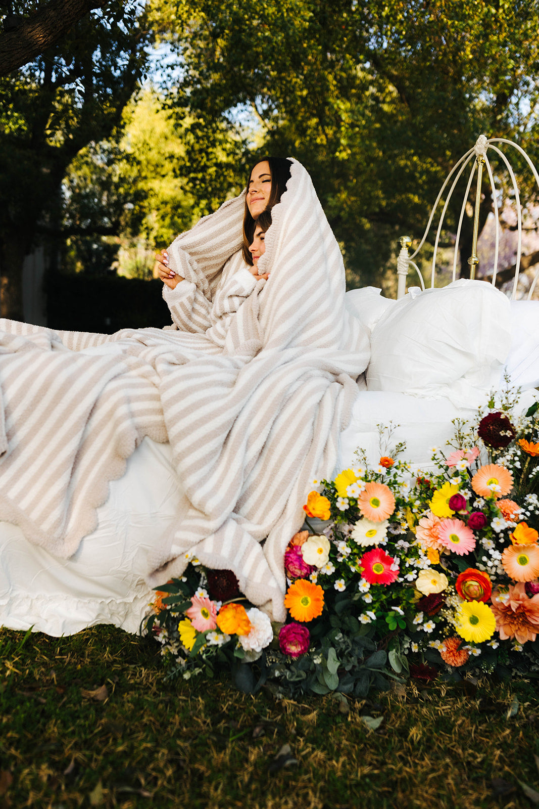 wrapped in the sand pinstripe blanket on the bed posing