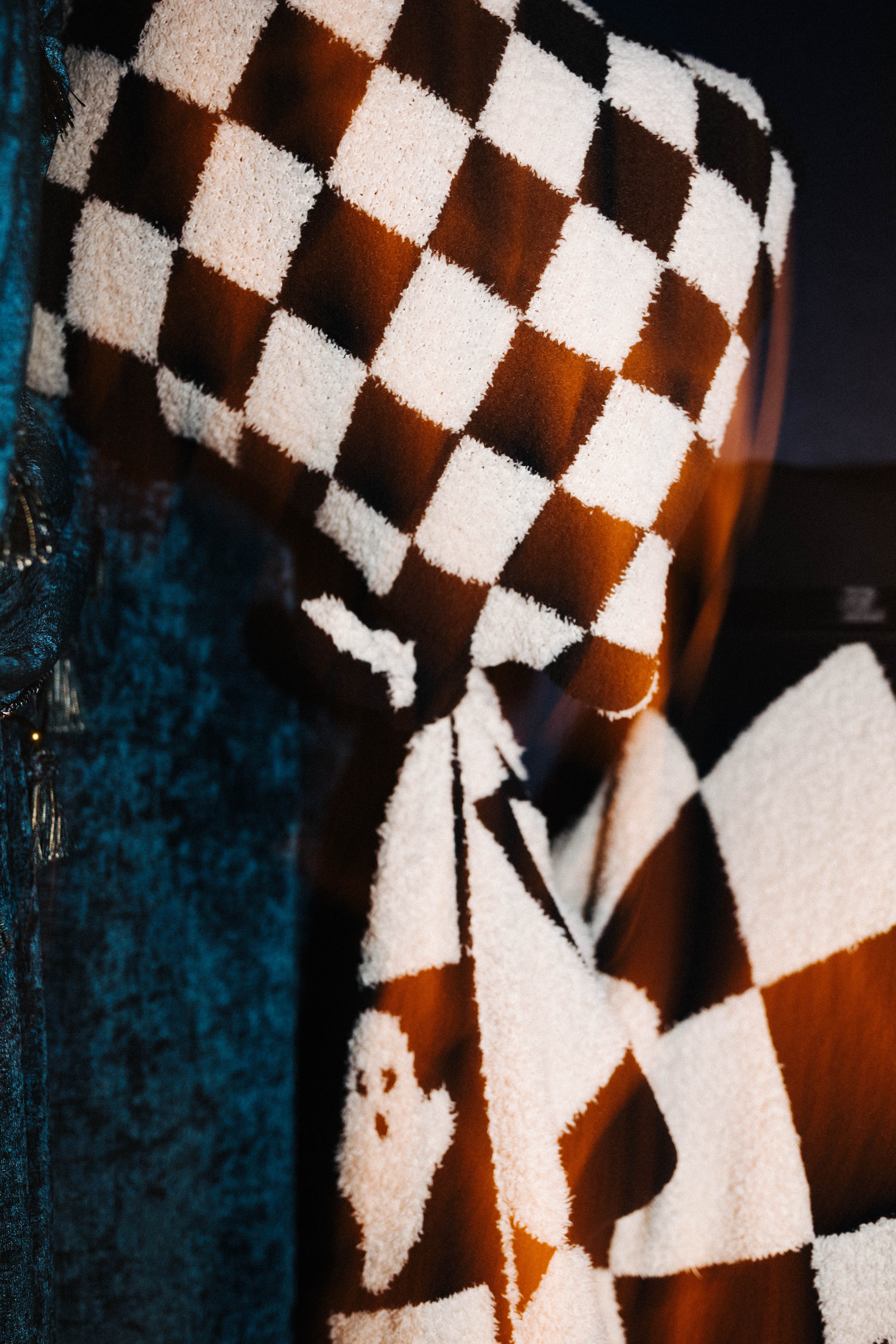 Close view of a ghost motif on the check blanket