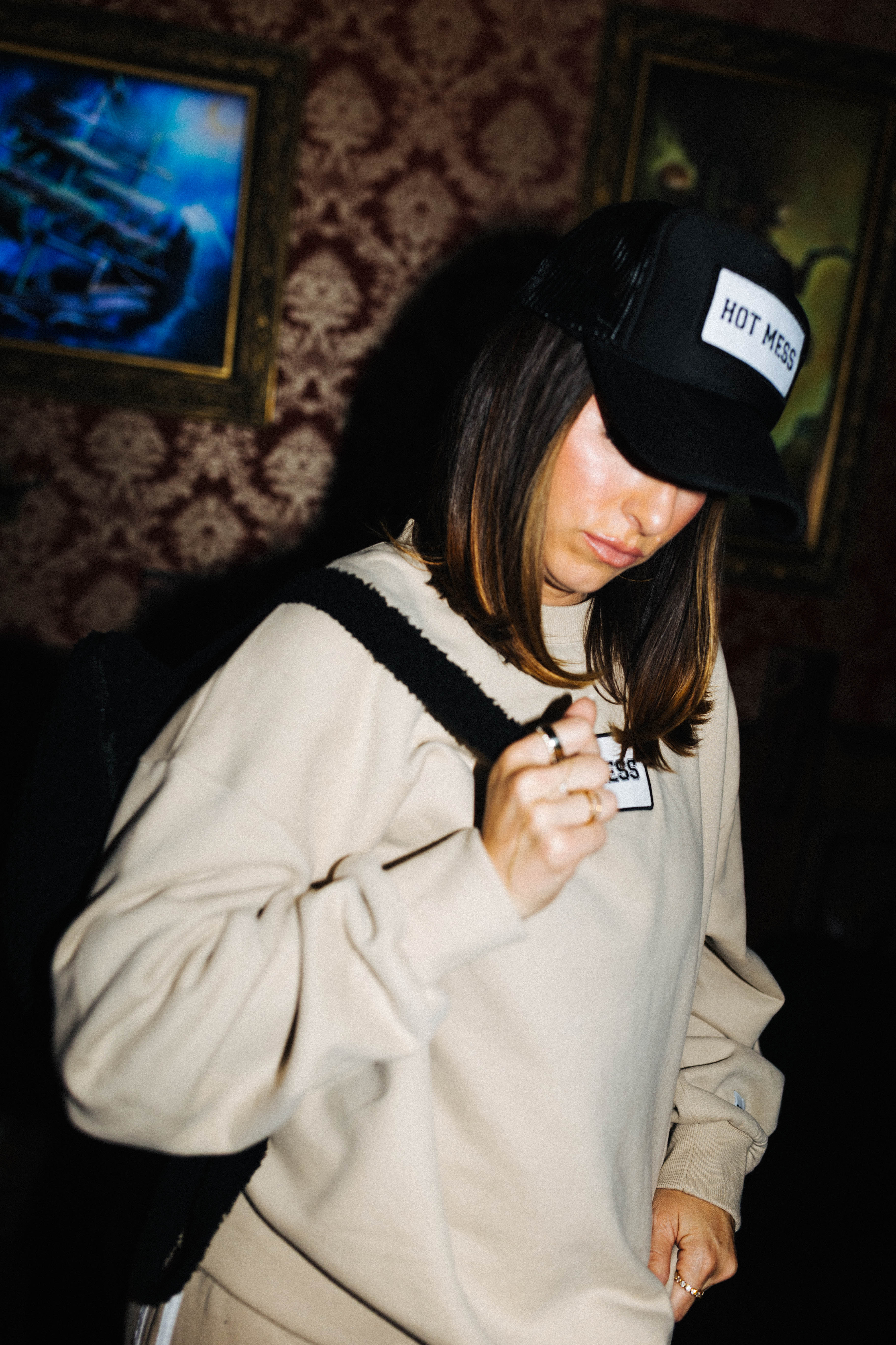 Black Hot Mess hat styled with a matching patch sweatshirt