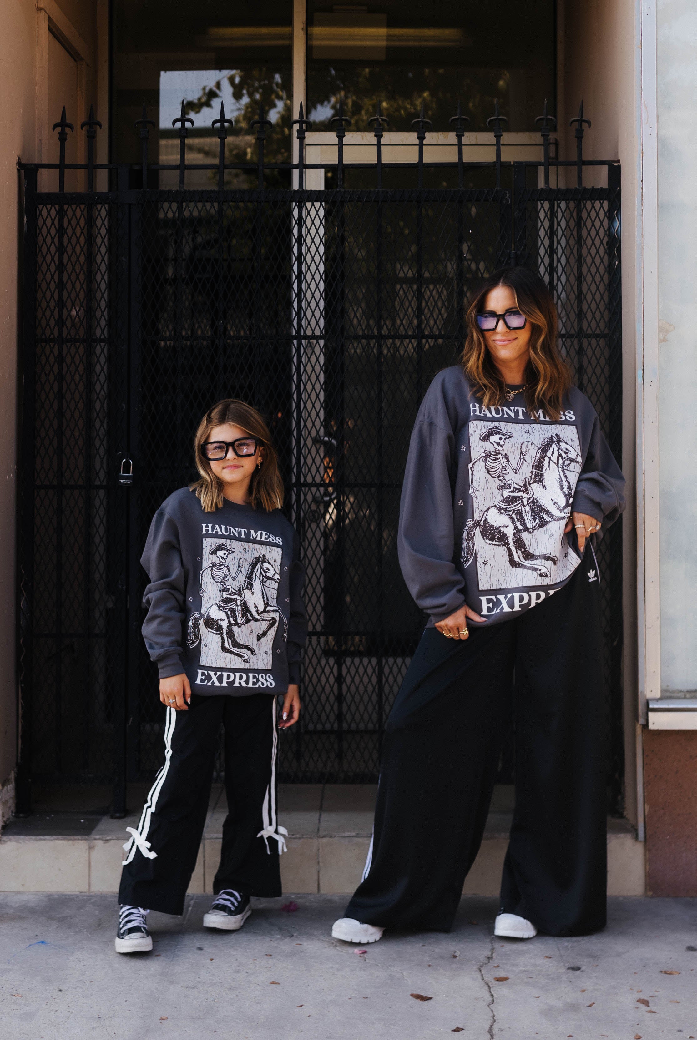 models krista and kolly wearing adult and youth haunt mess express sweatshirts